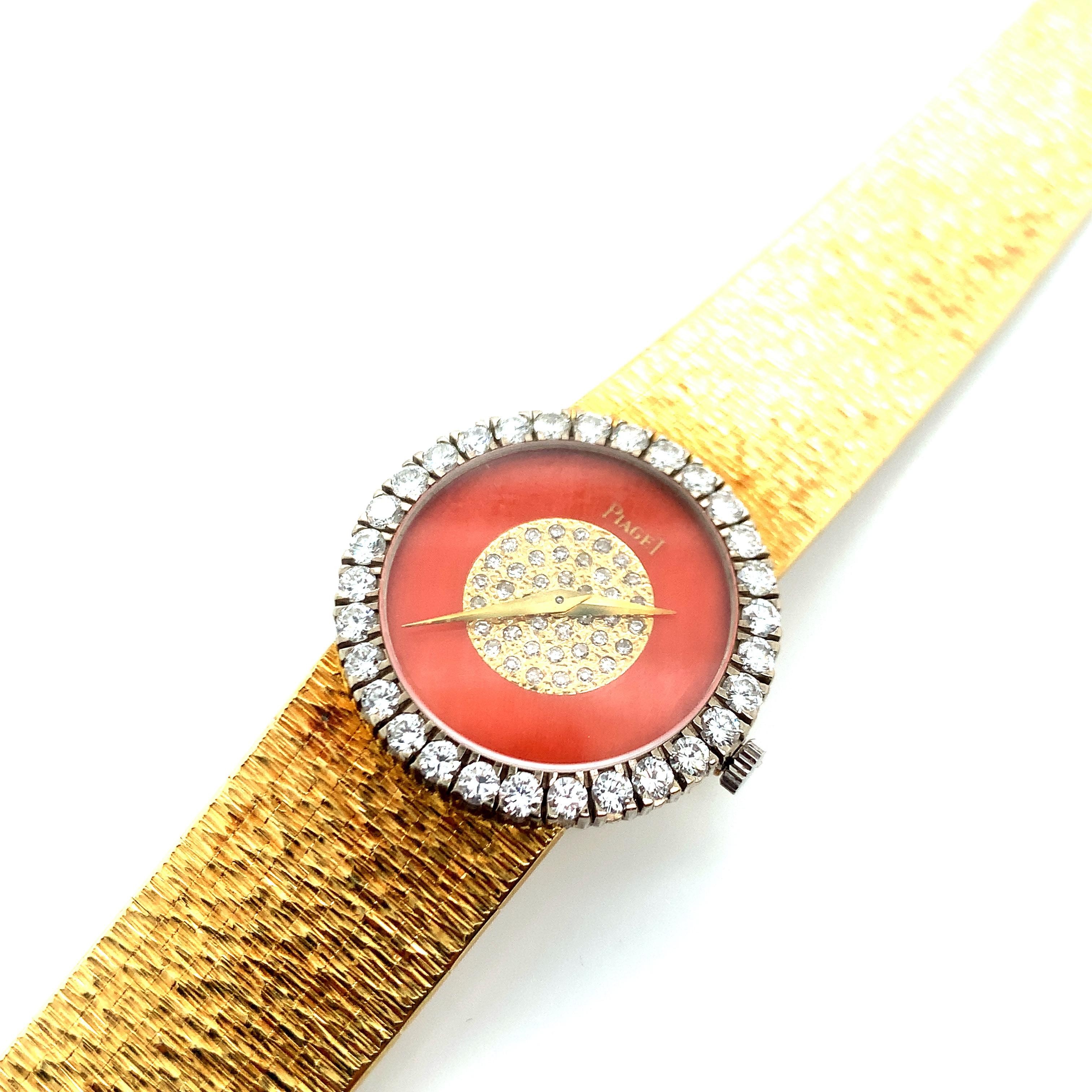Signed Piaget, this watch has a dial made out of coral with diamonds at its center. Bigger diamonds line the dial's perimeter. These diamonds weigh approximately 1.2 carat. The straps are made out of 18 karat yellow gold. Total weight is 59.5 grams.
