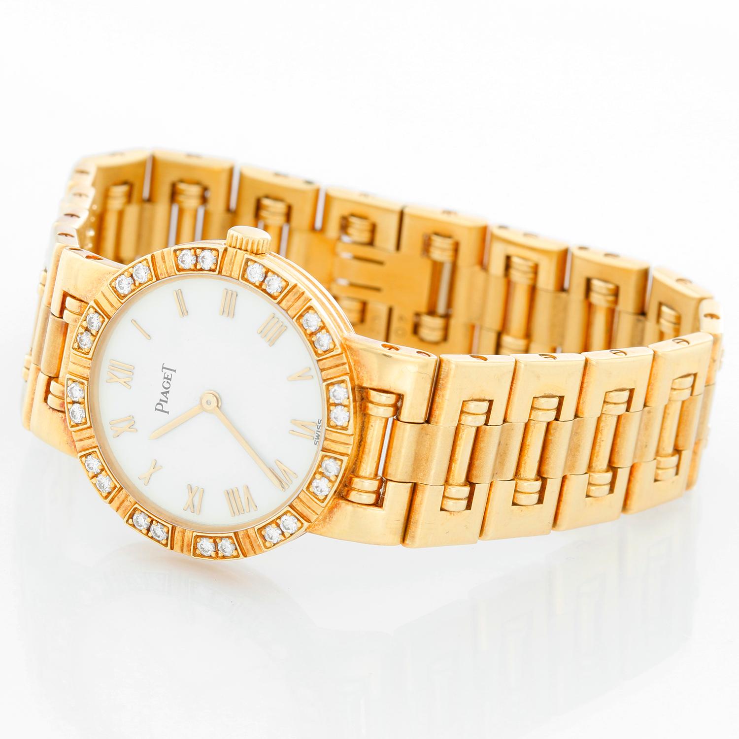 Piaget Dancer 18K Yellow Gold Ladies Watch - Quartz. 18K Yellow gold with diamond bezel (23 mm). White dial with gold Roman numerals. Piaget link bracelet with hinged clasp; fits up to a 5 3/4. Pre-owned with custom box. 