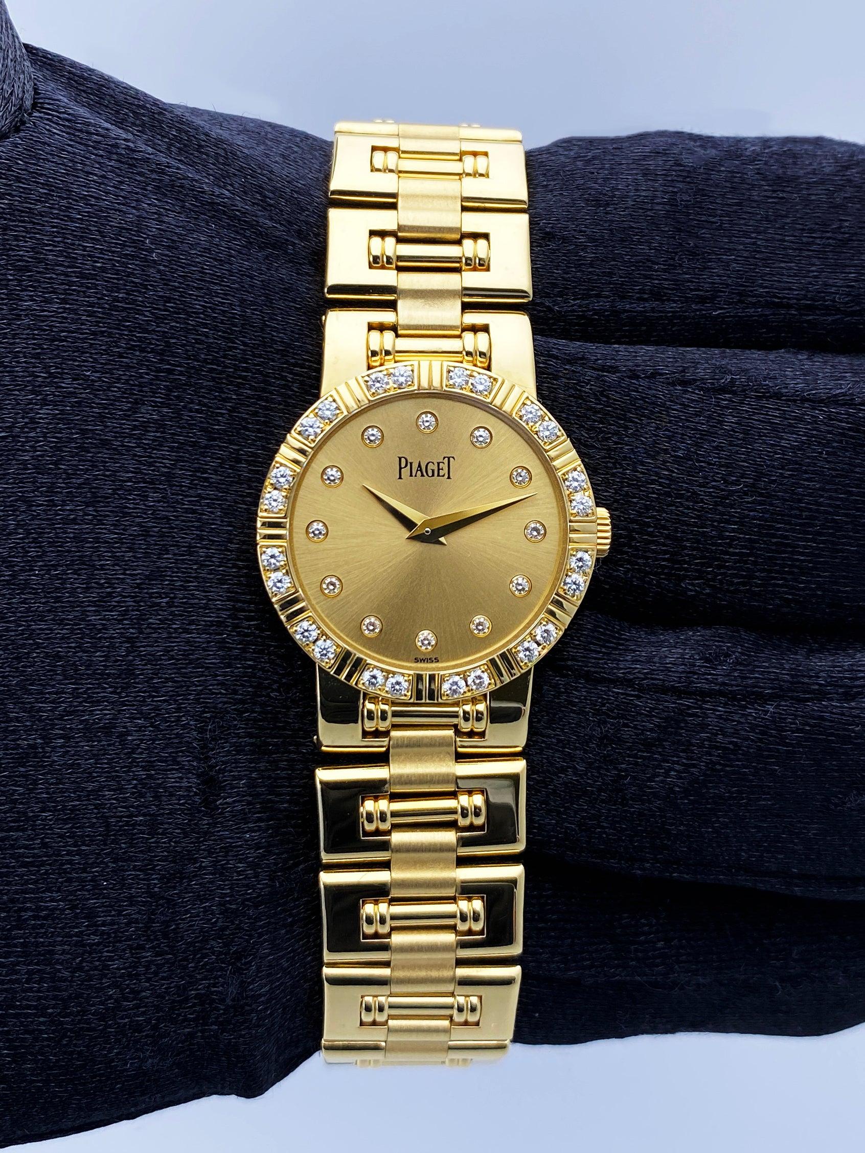 Piaget Dancer 80564 K81 Ladies Watch. 23mm 18K yellow gold case. 18K white gold bezel with original factory diamond insert. Champagne dial with gold hands and factory diamond hour markers. Date display at 3 o'clock position. 18K yellow gold bracelet