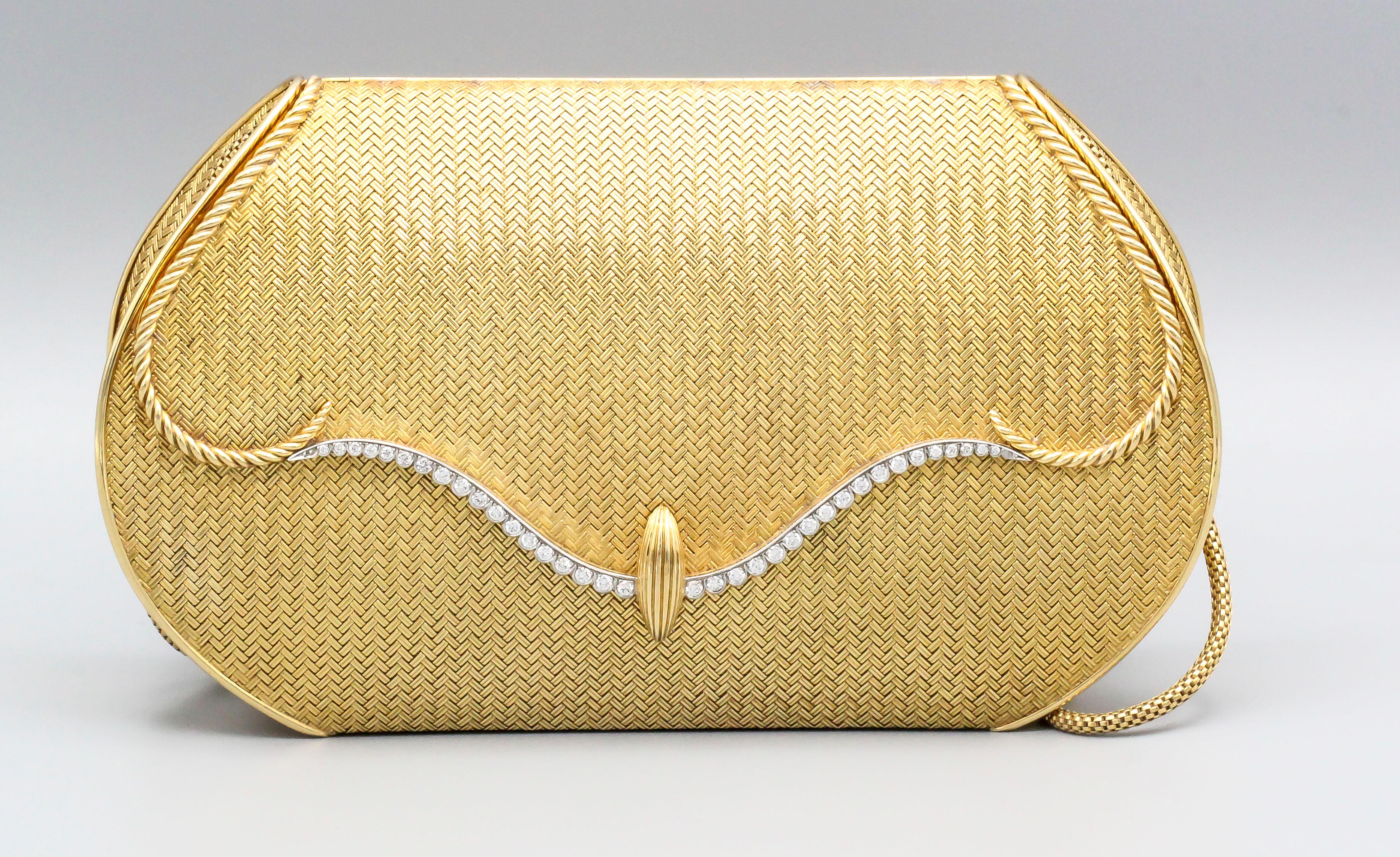 Very fine diamond and 18K gold mesh purse by Piaget, circa 1970s. It features an 18K gold short shoulder strap. Once opened, the purse reveals a large mirror and enough space to fit a modern day smart phone and several accessories.  The chain is