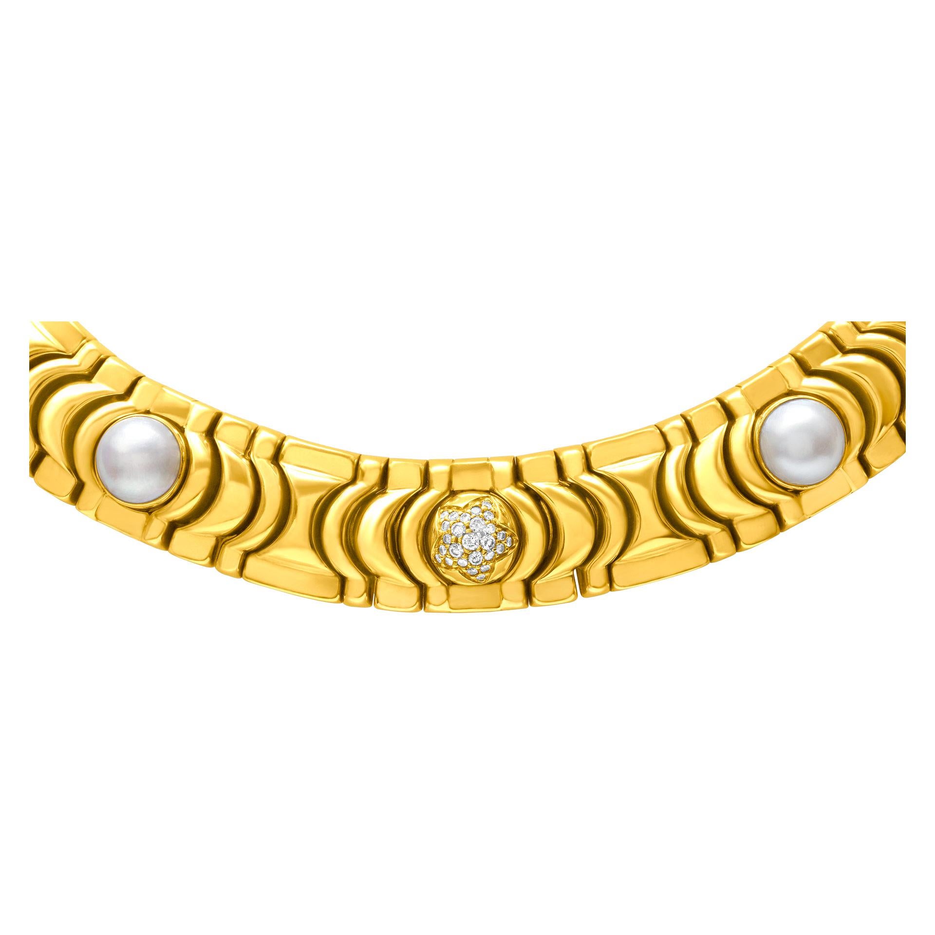 ESTIMATED RETAIL: $42,000 YOUR PRICE: $17,880 - Piaget choker necklace in 18k with pearl, gold bead & single-center pave F-G color, VVS-VS clarity diamond sections. Will fit up to 15
