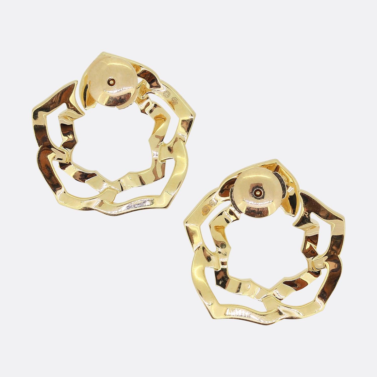 This is a fabulous semi-abstract pair of diamond earrings from the world renowned luxury jewellery brand, Piaget. Each piece has been rendered in warm 18ct rose gold to form the shape of a rose flower head; the inside open frame of which has then