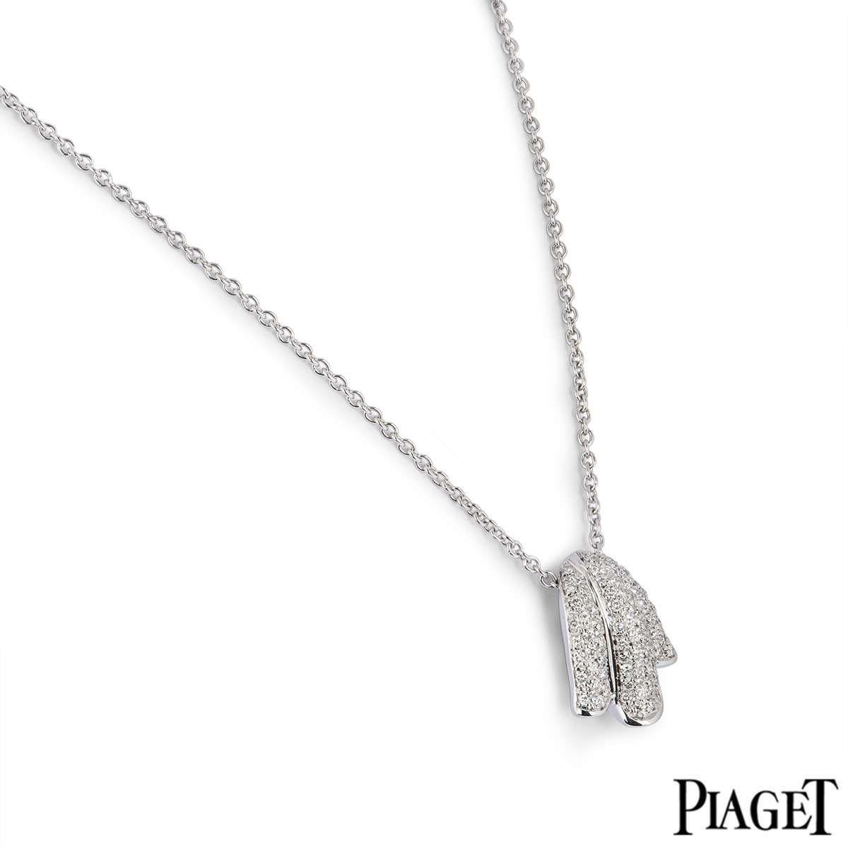 A beautiful earring and pendant suite by Piaget. The earrings and pendant feature a tulip design, pave set with round brilliant cut diamonds. The pendant motif measures 1.8cm in length and comes on a 16 inch chain, complete with lobster clasp. The
