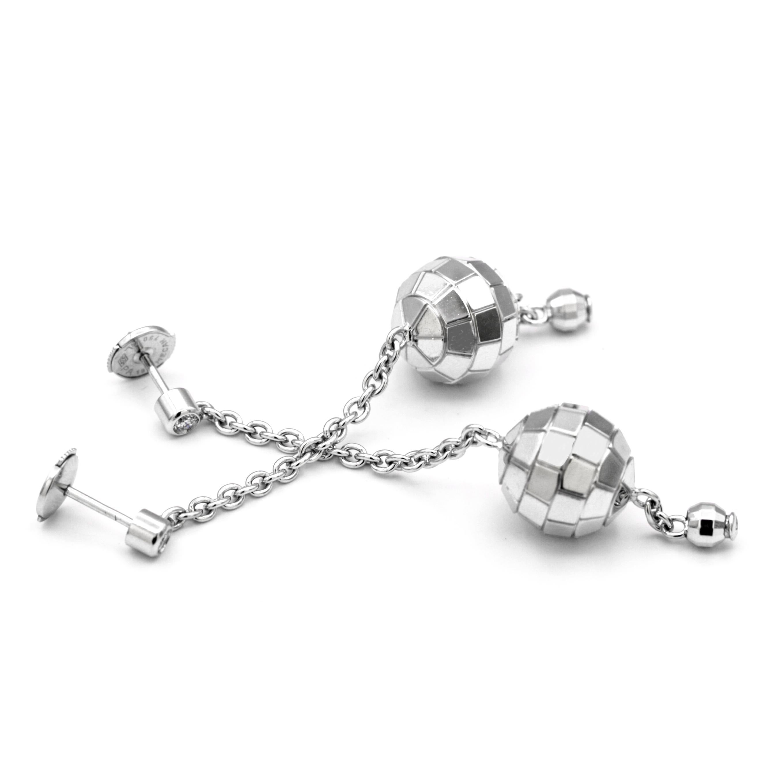 This set of Piaget dangling 18K white gold earrings with bezel set diamond at top of each; the disco ball motif and clutch back closures.
It is sure to start a party anywhere you take them!
This piece will arrive in an elegant Piaget jewelry