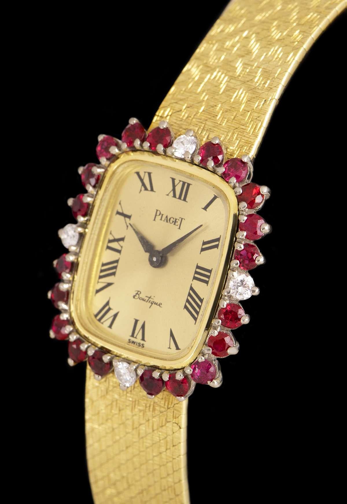 A 25 mm 18kYellow Gold Women's Dress Wristwatch, champagne dial with Roman numerals, a fixed 18k yellow gold bezel set with 20round brilliant-cut rubies and 4 round brilliant cut diamonds, an 18k yellow gold jewellery style bracelet with an 18k