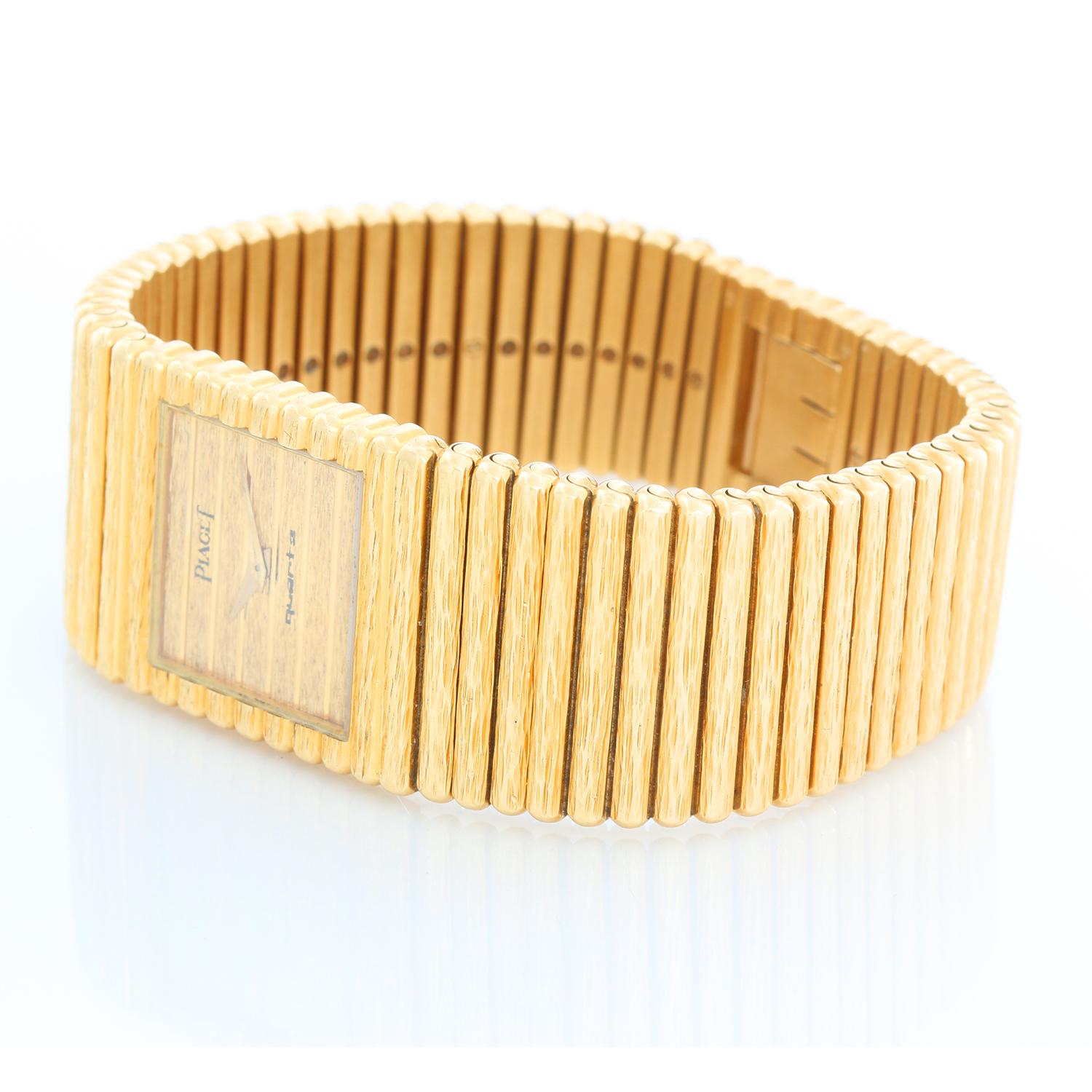 Piaget Emperador 18K Yellow Gold Bark Mens Watch - Quartz. 18K Yellow gold ( 24 mm ). Textured gold Dauphine hands and sapphire crystal. 18K Yellow gold bark integral bracelet; Will fit a 6 3/4 bracelet. Pre-owned with custom box.