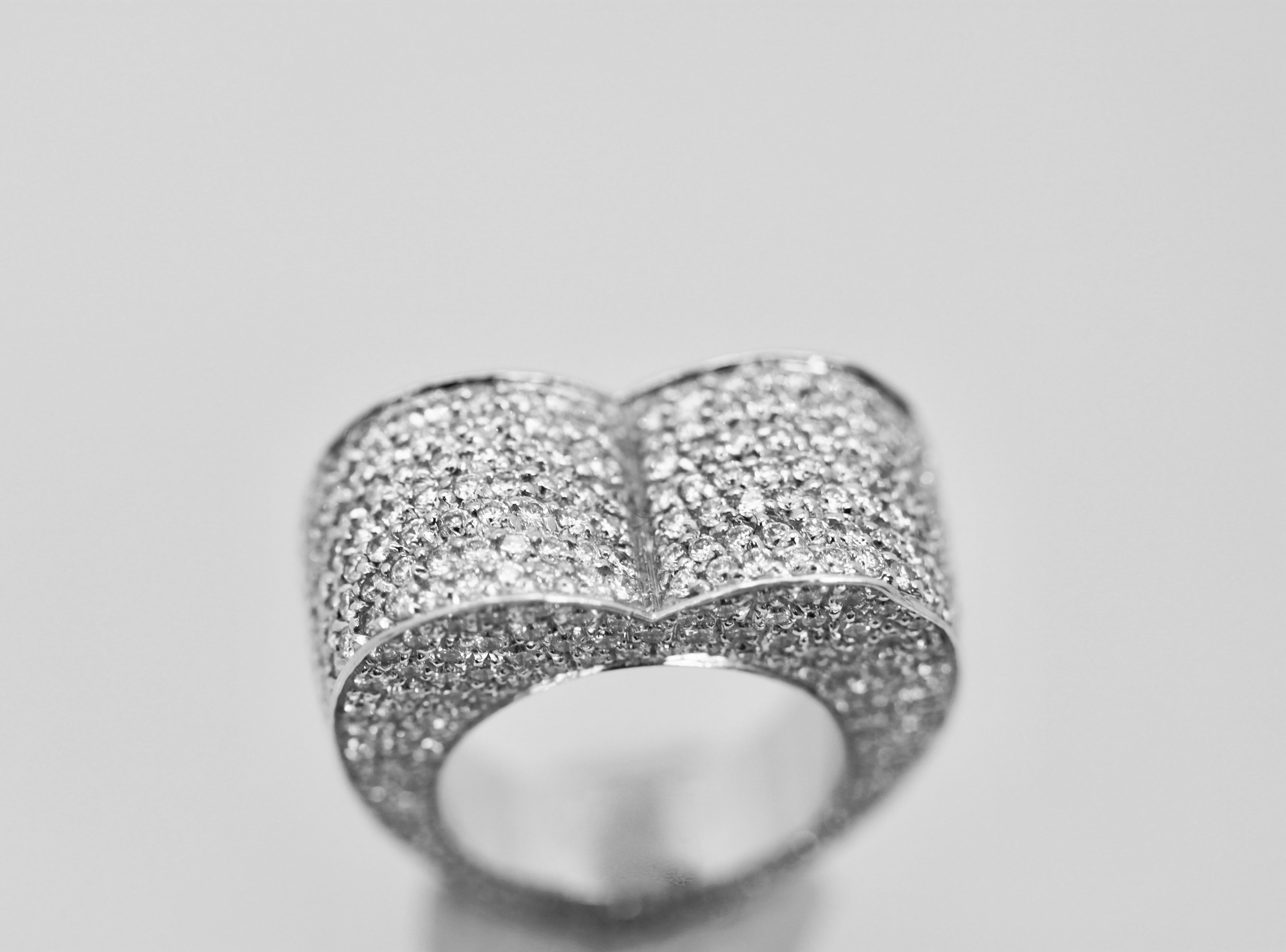 This Piaget Diamond heart ring is no longer made and it is massive.  This ring boasts 524 Diamonds approximately 5.24 Carats in total in 18K White Gold.  It is in fine condition.  This ring retailed for $18,000.
This ring is a size 5.5 and can not