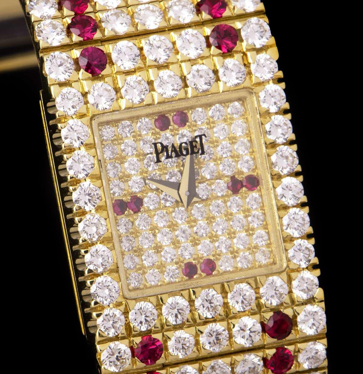 An 18k Yellow Gold Fully Loaded Vintage Ladies Wristwatch, pave diamond dial set with 2 round brilliant cut rubies at 3, 6, 9 and 12 0'clock, a fixed 18k yellow gold bezel set with 26 round brilliant cut diamonds, an 18k yellow gold jewellery style