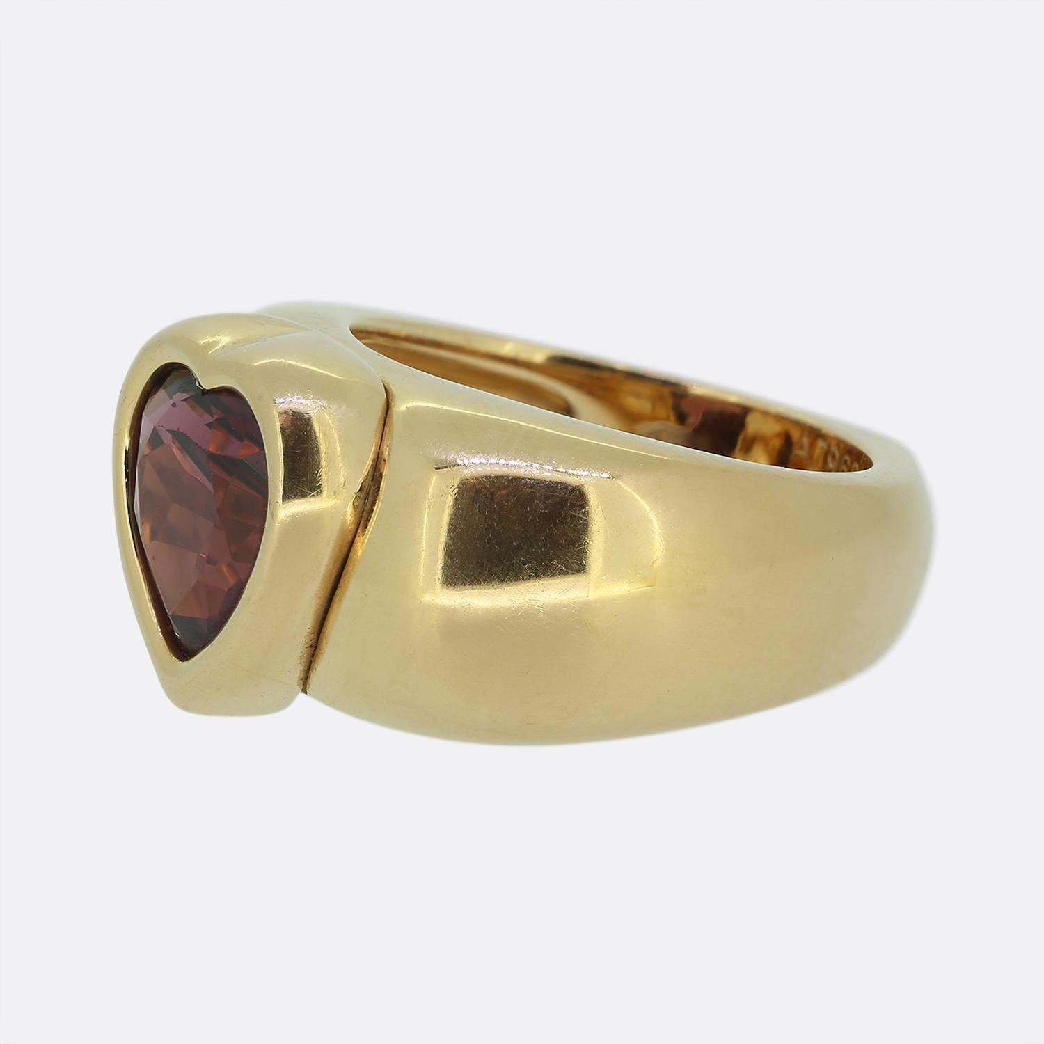 Here we have a striking creation from Piaget. This large statement ring showcases a single heart-cut garnet set in luxurious 18ct rose gold. The bold design features a wide plump band that elegantly frames the deep red focal stone, enhancing its
