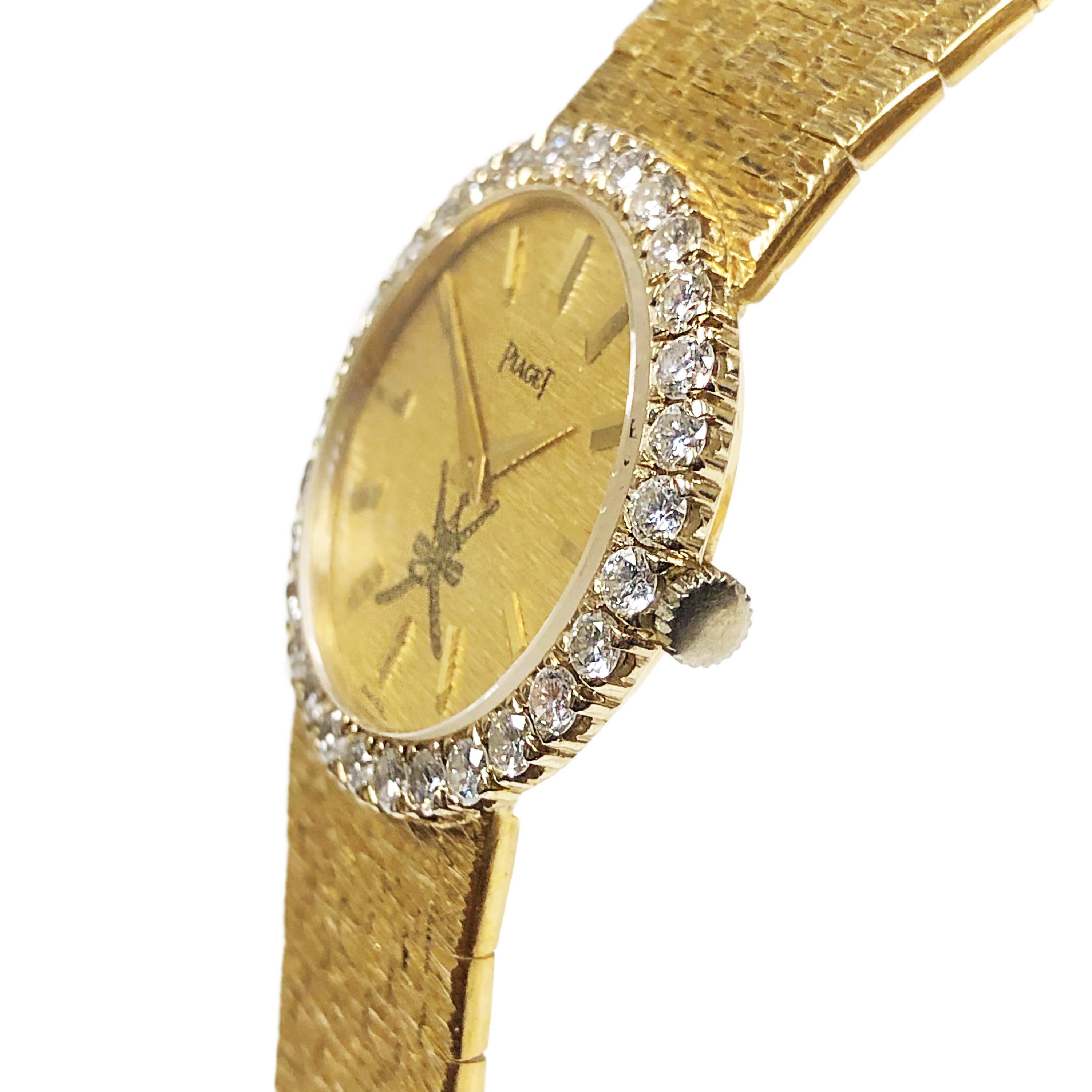 Circa 1980 Piaget Ladies Wrist Watch Retailed By Asprey london, 25 MM 2 piece case 18K Yellow Gold case with White Gold bezel set with 30 Round Brilliant cut Diamonds totaling 1.50 Carats and grading as F-G in color and VS in clarity. 17 Jewel