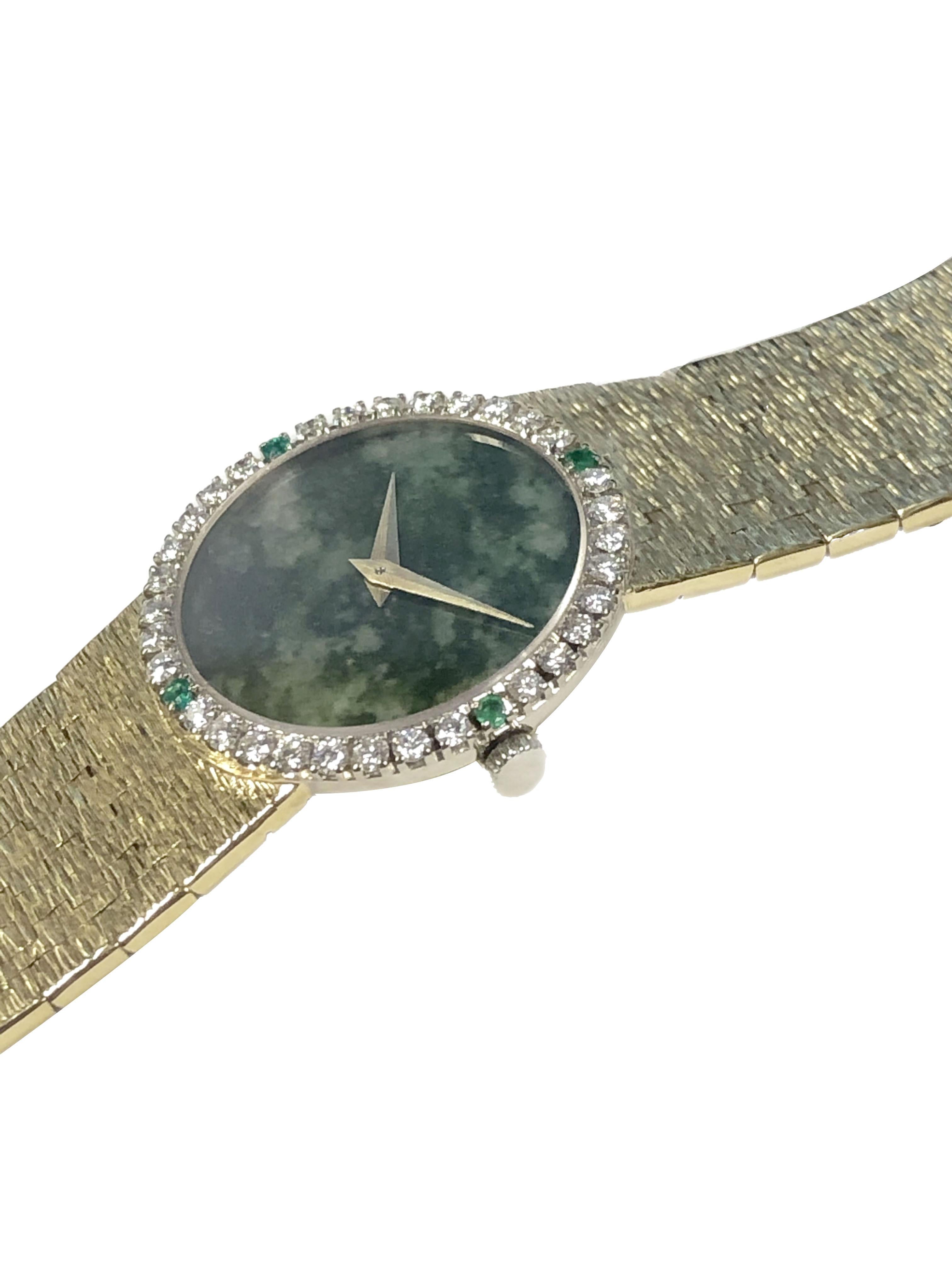 Circa 1970s Ladies Piaget Wrist Watch, 24 M.M. 18K yellow Gold 2 piece case, Diamond and Emerald set Bezel, 17 jewel mechanical, manual wind movement. Jadite stone dial. 5/8 inch wide soft flexible textured bracelet, watch length 7 inches. Recently