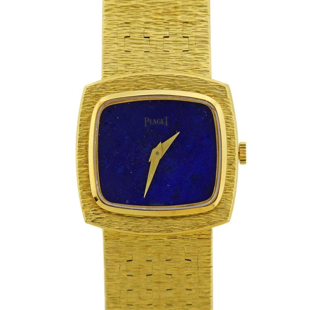 18k yellow gold watch by Piaget, featuring lapis dial with Piaget logo and hold hands. 18k gold bracelet is 7