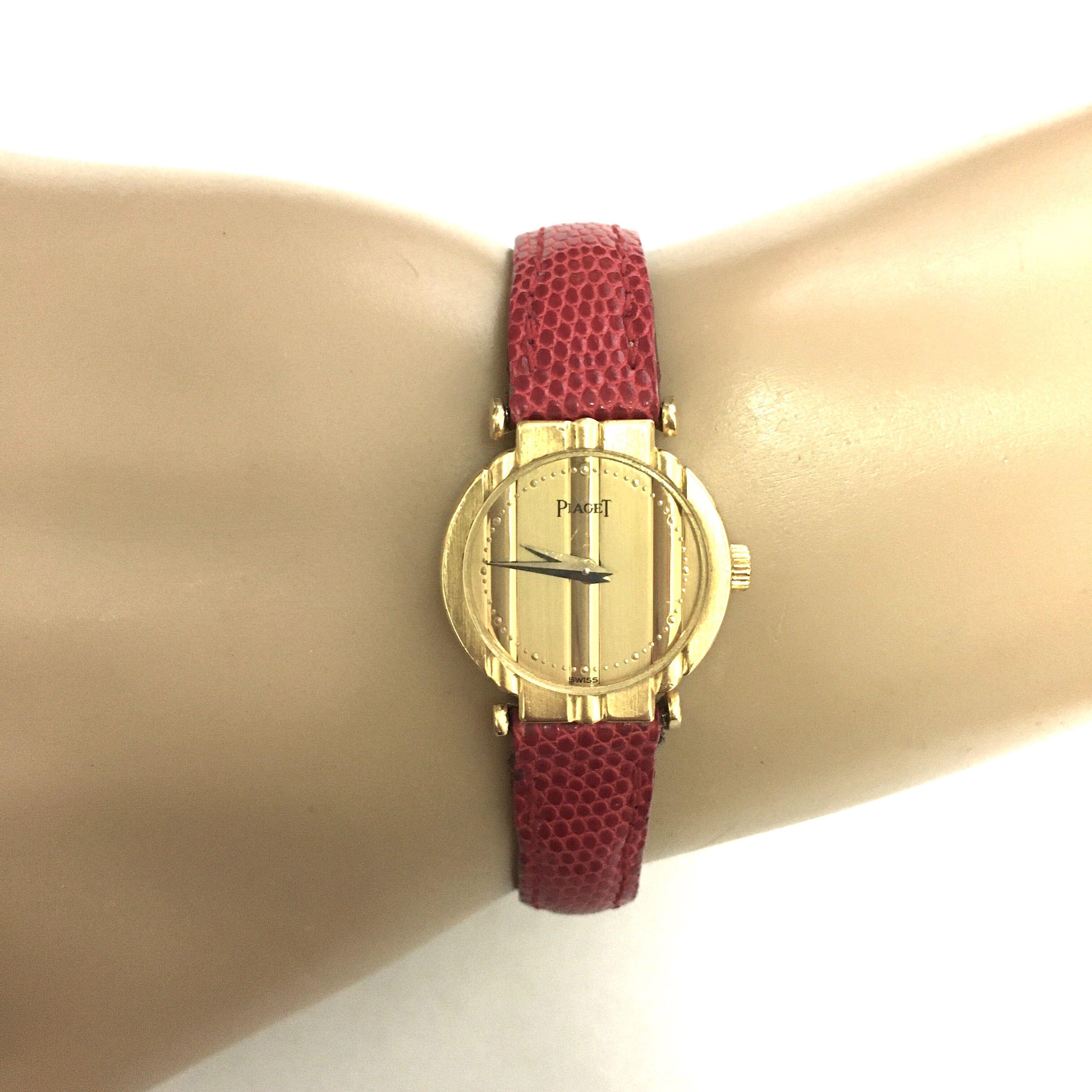 18 karat gold Polo watch. Piaget. 19mm. Of quartz movement. With red leather band.