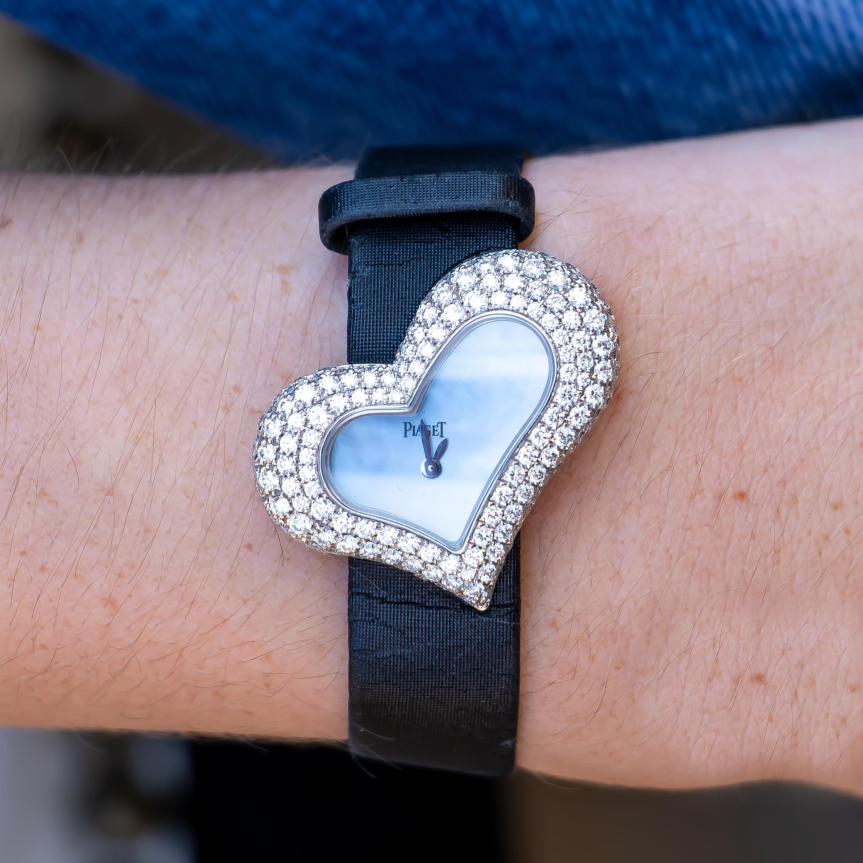 Brand: Piaget

Model # GOA29131

Movement: Quartz, Swiss Made

Case/Dial: Mother Of Pearl Dial, 18K White Gold Heart Shape Case With Factory Set Diamonds 38mm Width

Bracelet: 18K White Gold & Piaget Diamond Set Buckle

Wrist Size: