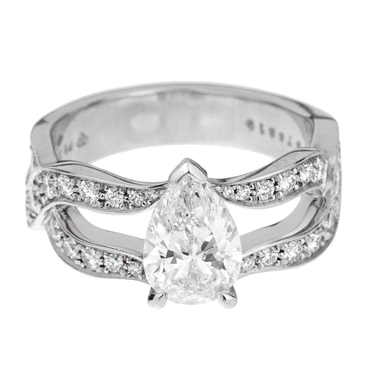 A pear-cut diamond engagement ring from the famed Swiss jeweler Piaget. The fluidity of the platinum band, which is entwined in a double loop set with 50 round brilliant-cut diamonds, supports the beautiful pear-cut diamond solitaire. The pear