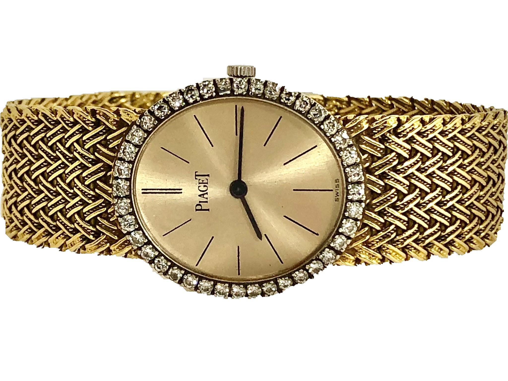 This lovely, ultra thin, 18K Yellow Gold Piaget ladies mid 20th century cocktail 
watch has a vertical oval champagne colored dial with black stick markers at
every position. The bezel surrounding the dial is set with 40 brilliant cut