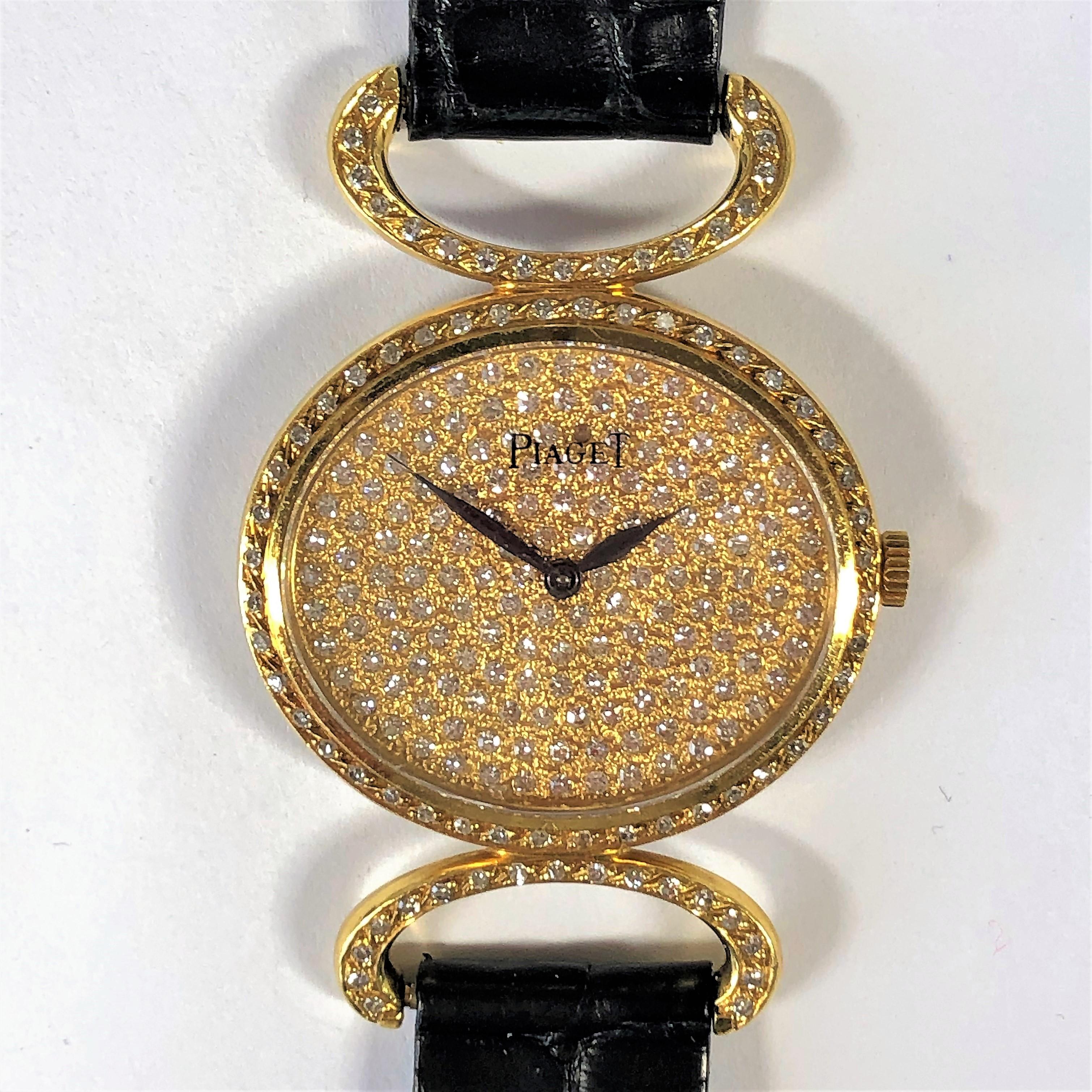 Piaget's elegant yet sporty 18K gold and diamond wristwatch is masterfully designed, with 4 sections of black, alligator strap, connected by gold and diamond encrusted stations matching the diamond encrusted lugs and diamond encrusted buckle. The