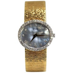 Piaget Ladies Gold Watch with Blue Gray Mother of Pearl Diamond Dial and Bezel