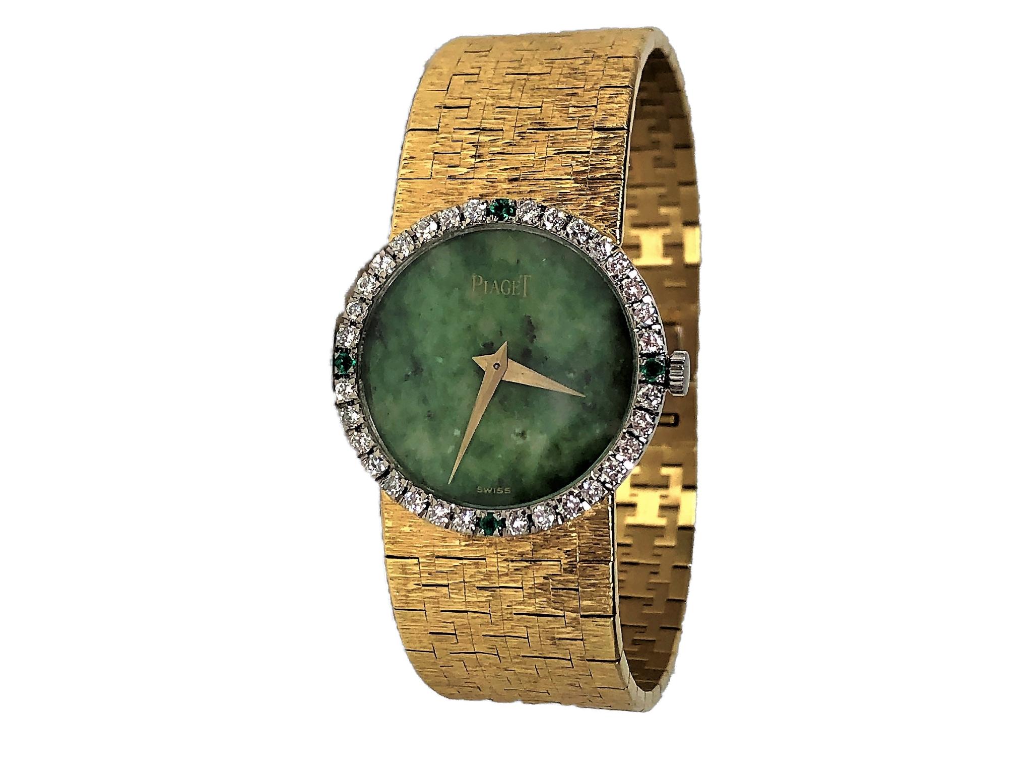 This much sought after 18K Yellow Gold, round Jade Dial Piaget, is set with a diamond bezel with four brilliant emeralds. The diamond weight is approximately 1.00CT of overall F Color  VS1 Clarity diamonds. The bark finish integral band measures 6