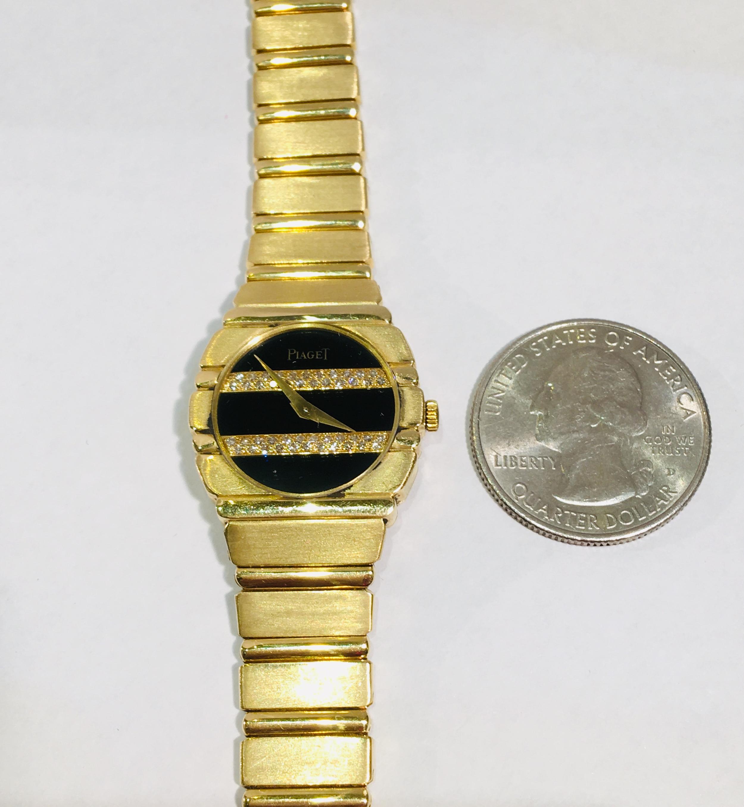 18 karat yellow gold ladies Piaget Polo watch features a round black onyx face with two signature horizontal double rows of diamond pave stripes and floating gold hands.  Crystal is scratch-resistant sapphire.  Solid 18k gold case and bracelet