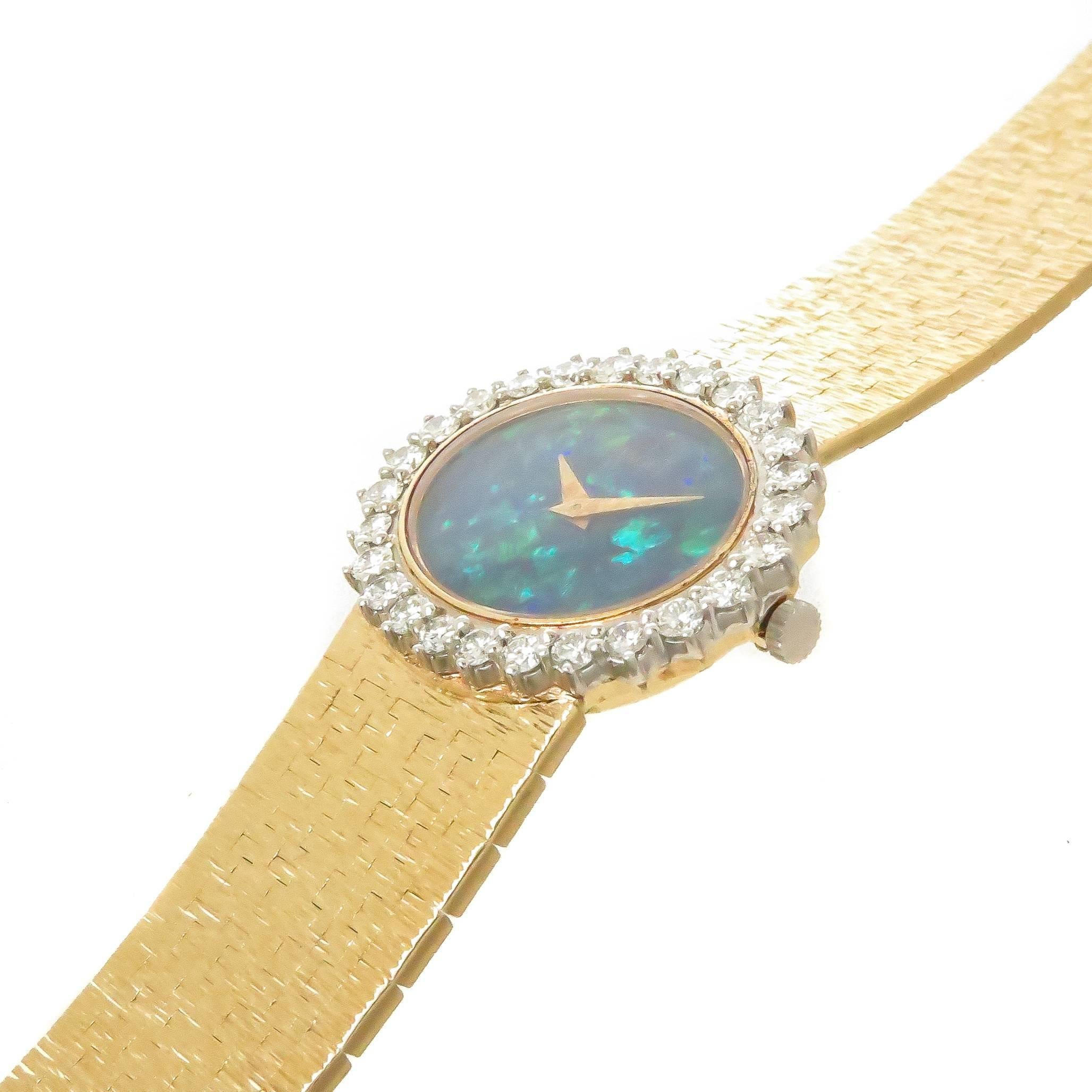 Circa 1980 Piaget Ladies Wrist Watch, 25 X 24 MM 18K Yellow Gold Oval case, Diamond set Bezel of 26 round Brilliant cuts totaling 1.50 Carats and Grading as G in color and VS in clarity. Very Fine Black opal dial, 17 jewel Mechanical, Manual wind