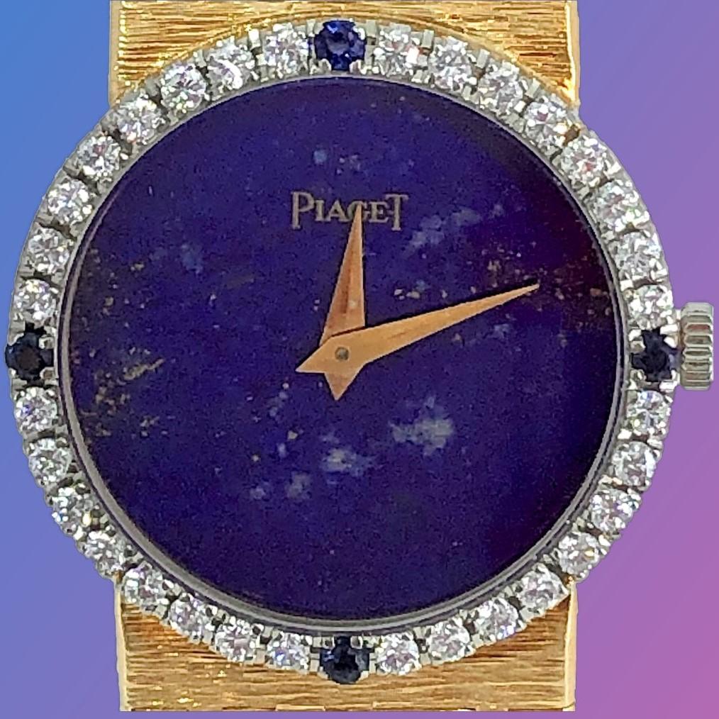 Piaget Ladies 18K Yellow Gold bracelet watch. The round deep blue 
lapis dial displays many of the natural characteristics of the stone. It is complimented by four sapphires set into the diamond bezel at the 
12, 3, 6 and 9 o'clock positions. The