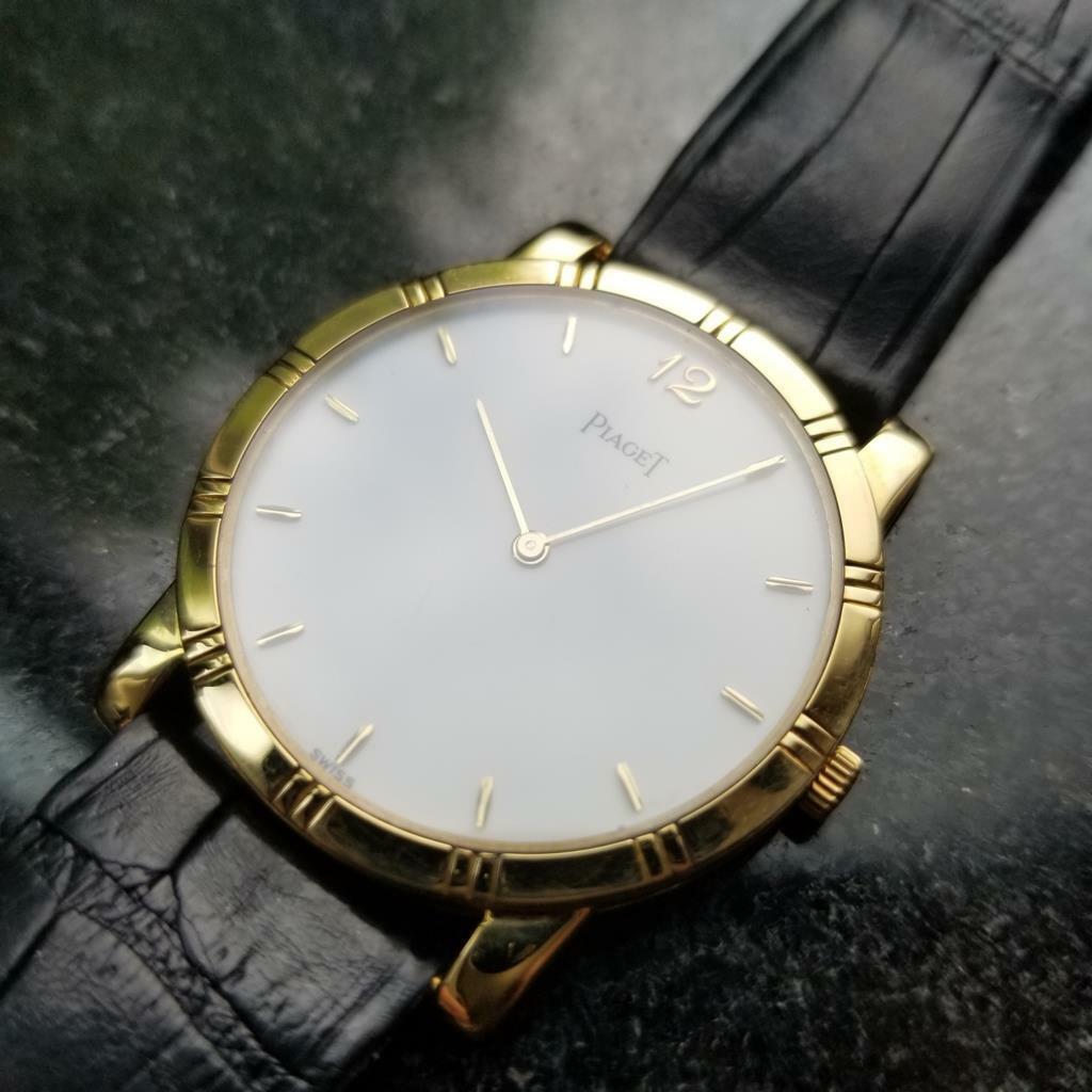 Luxury elegance, men's midsize Piaget Dancer 18K gold dress watch, c.1990s, all original. Verified authentic by a master watchmaker. Gorgeous clean ivory white Piaget dial, applied gold baton hour markers, Arabic numeral 12, gold minute and hour