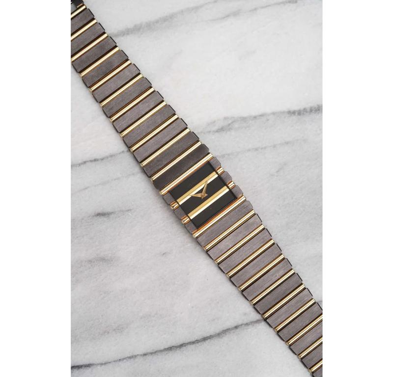 We're thrilled to offer one of the rarest and most elusive Piaget designs ever produced: the factory PVD-coated two-tone Piaget Polo Cuff, reference 7131, dating back to the 1980s. Beneath the sleek black coating lies a solid 18k yellow gold
