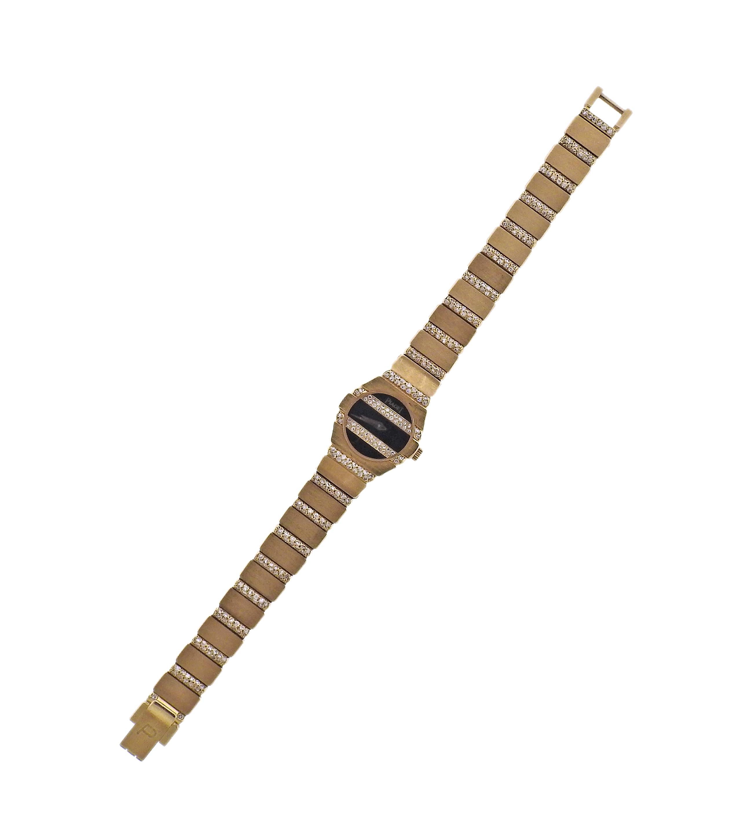 18k gold classic Polo watch by Piaget, with approx. 1.30ctw in diamonds and onyx dial. Bracelet is 6 2/8