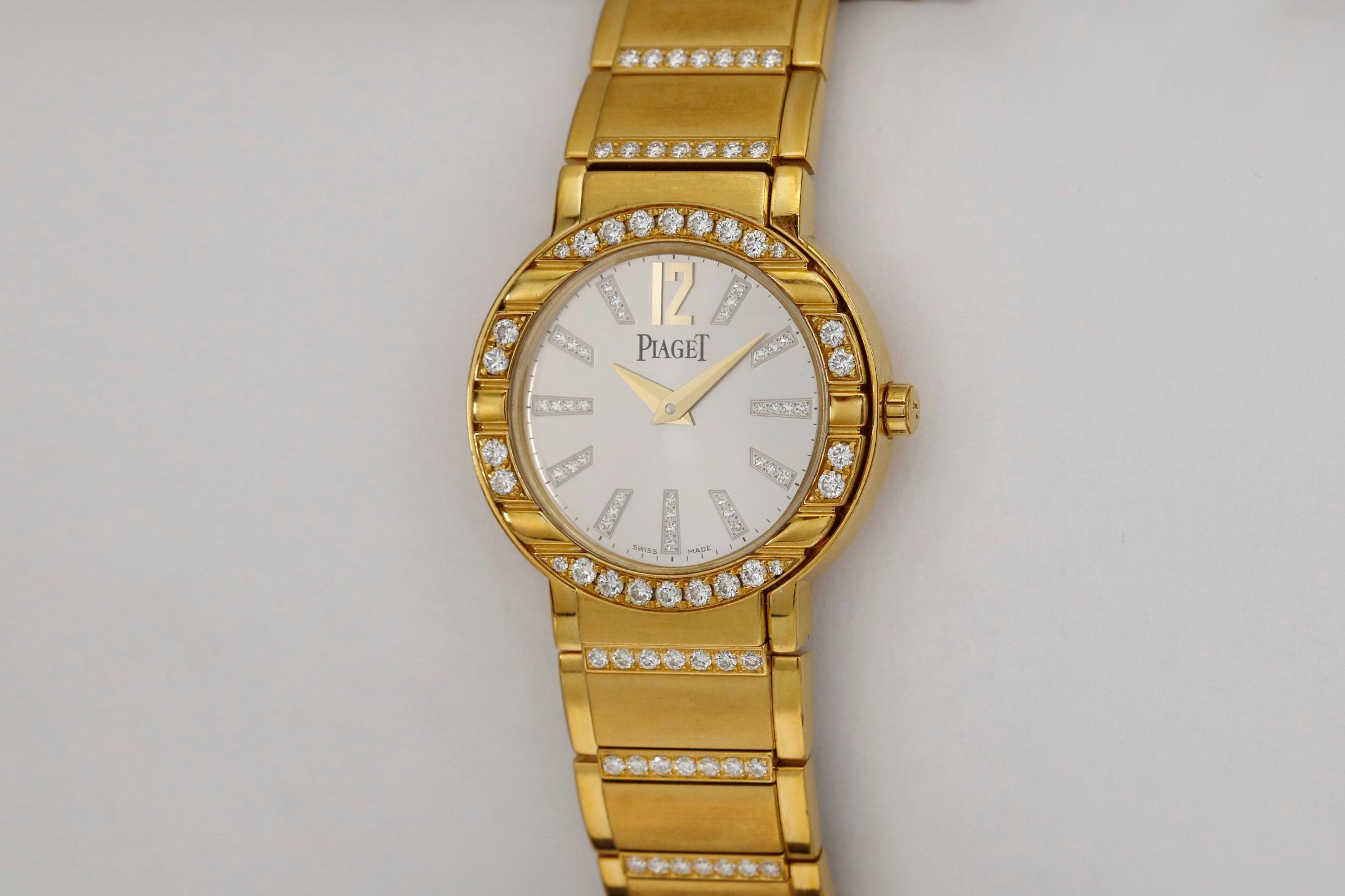 Piaget Polo reference P10141  with a 28mm 18k yellow gold case with diamonds. This watch is run by a quartz movement.   If you have any questions feel free to contact us. 