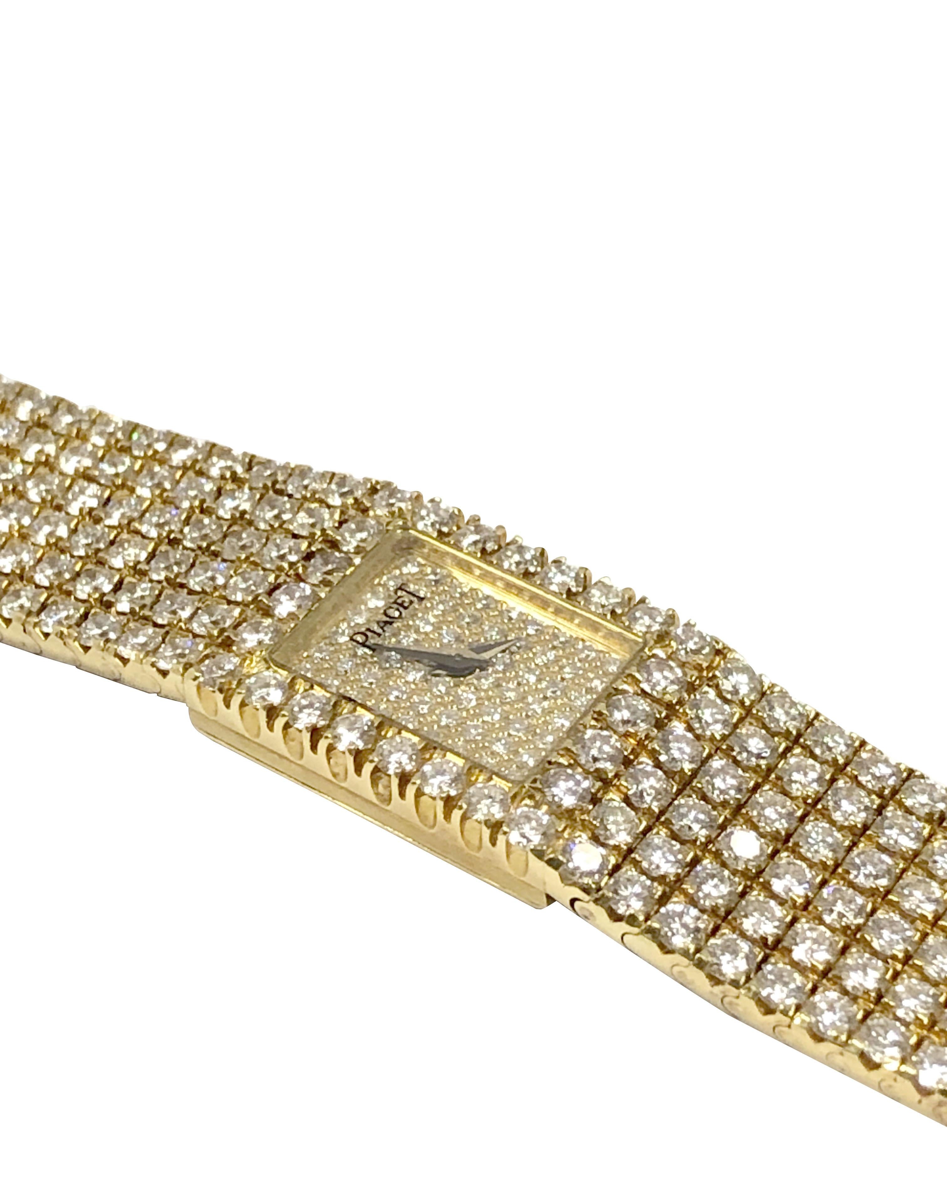 Circa 1990s Piaget Polo Reference 15201 Ladies 18k Yellow Gold Wrist Watch,  set with approximately 20 Carats of Fine White Round Brilliant cut Diamonds in a soft flexible bracelet, measuring 7 1/2 inches in length and just over 1/2 inch wide.