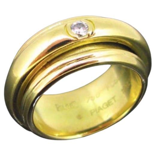 Piaget Possession Collection 3 Diamond Large Band Ring, 18 Karat Yellow Gold
 This bold ring is from Possession collection created by the swiss jewelry house Piaget. This one is made in 18kt yellow gold. The central band is moving around the larger