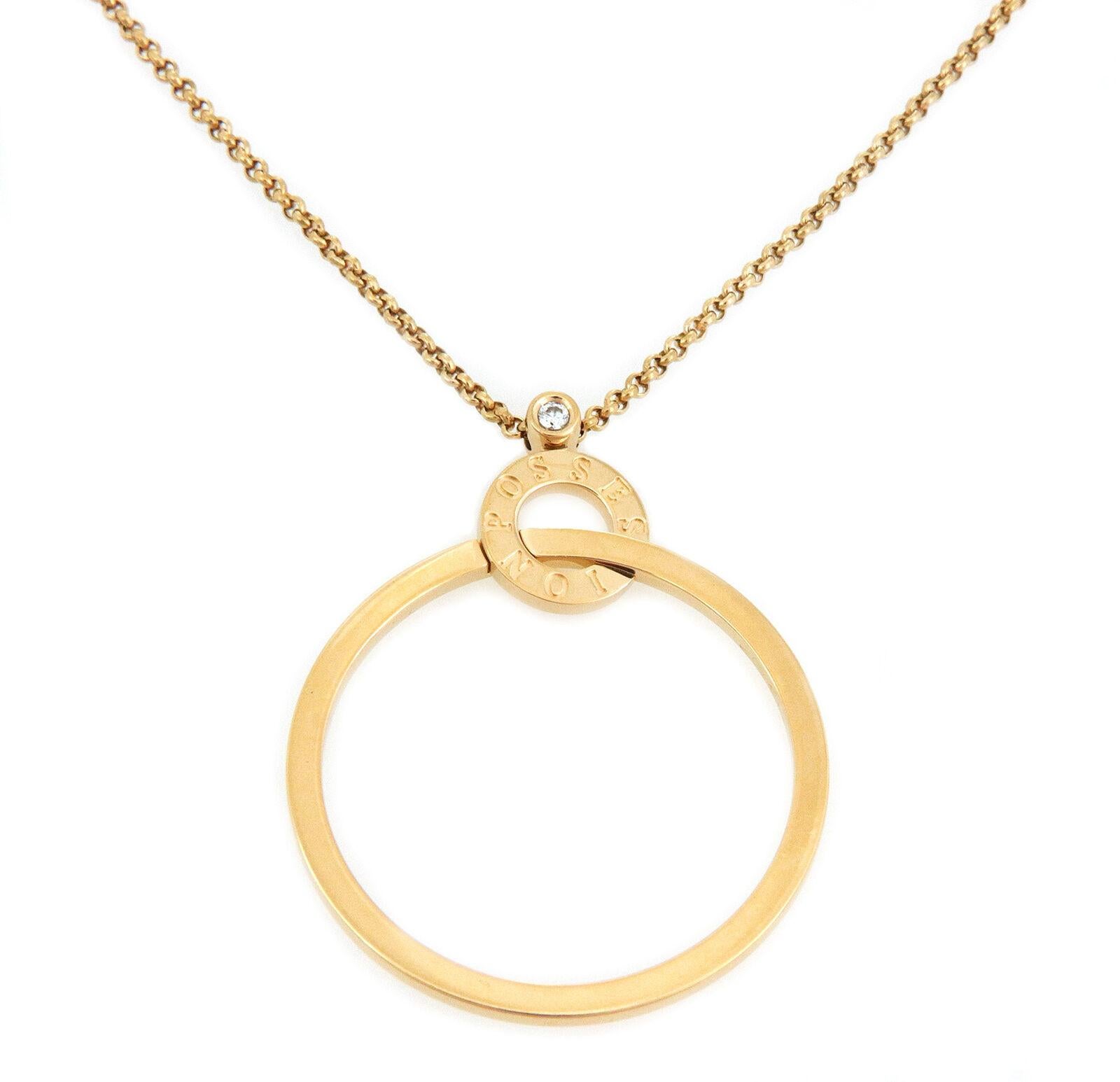 This chic authentic necklace is by Piaget from the Possession Collection. Crafted from 18k yellow gold with a high polished finish featuring a large open ring interlaced with a smaller ring above engraved Possession. The top of the pendant is