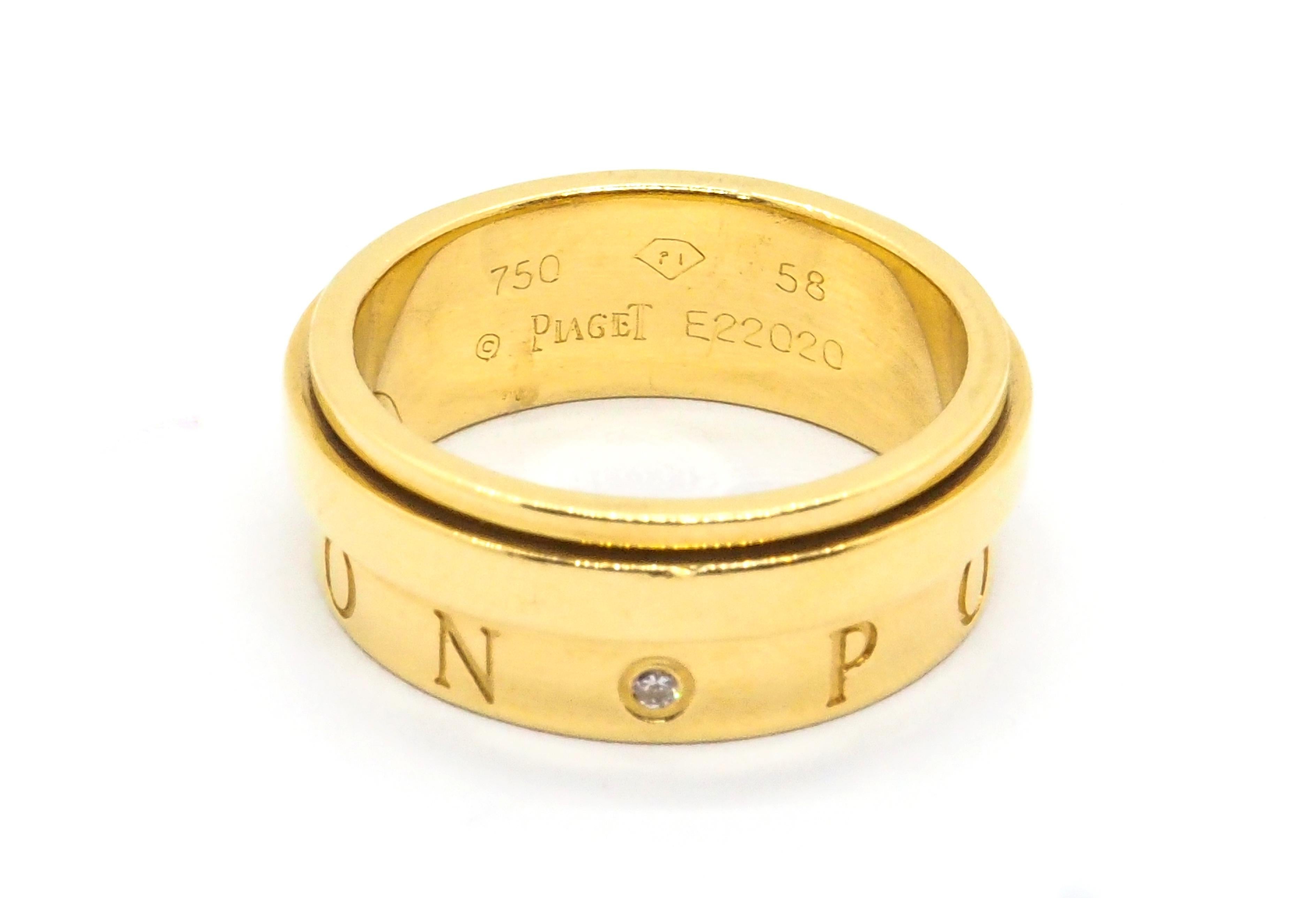 A 18k yellow gold Piaget Possession eccentric ring comprised of a plain band positioned to the upper edge set with one single diamond, which moves freely in a perpetual movement. The lower half of the inner band is engraved with the word