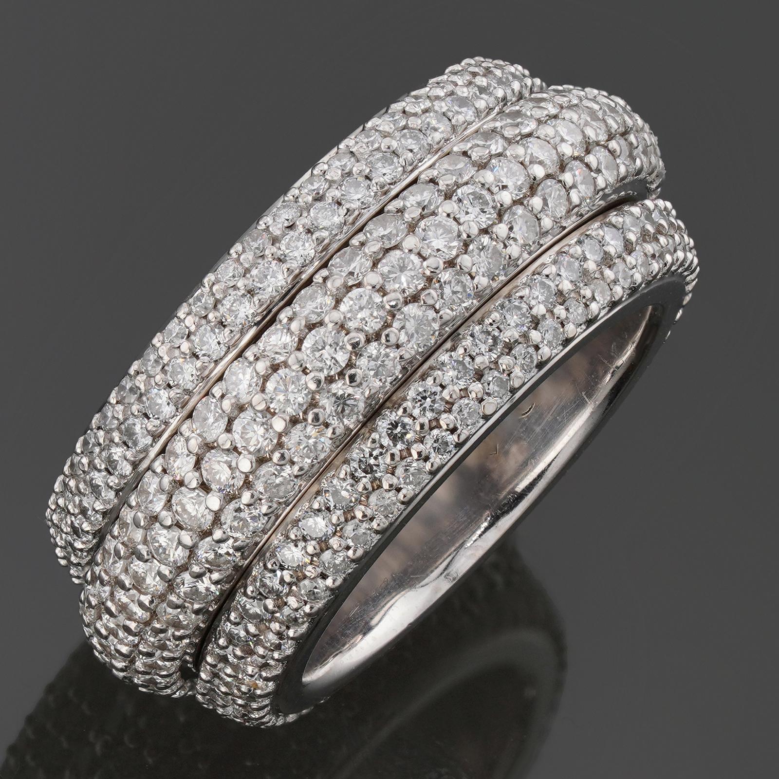 This gorgeous Piaget ring from the exquisite Possession collection features a 3-row design with a spinning middle band and is crafted in 18k white gold and fully set with 332 brilliant-cut round G-H VVS2-VS1 diamonds weighing an estimated 3.75 - 4.0