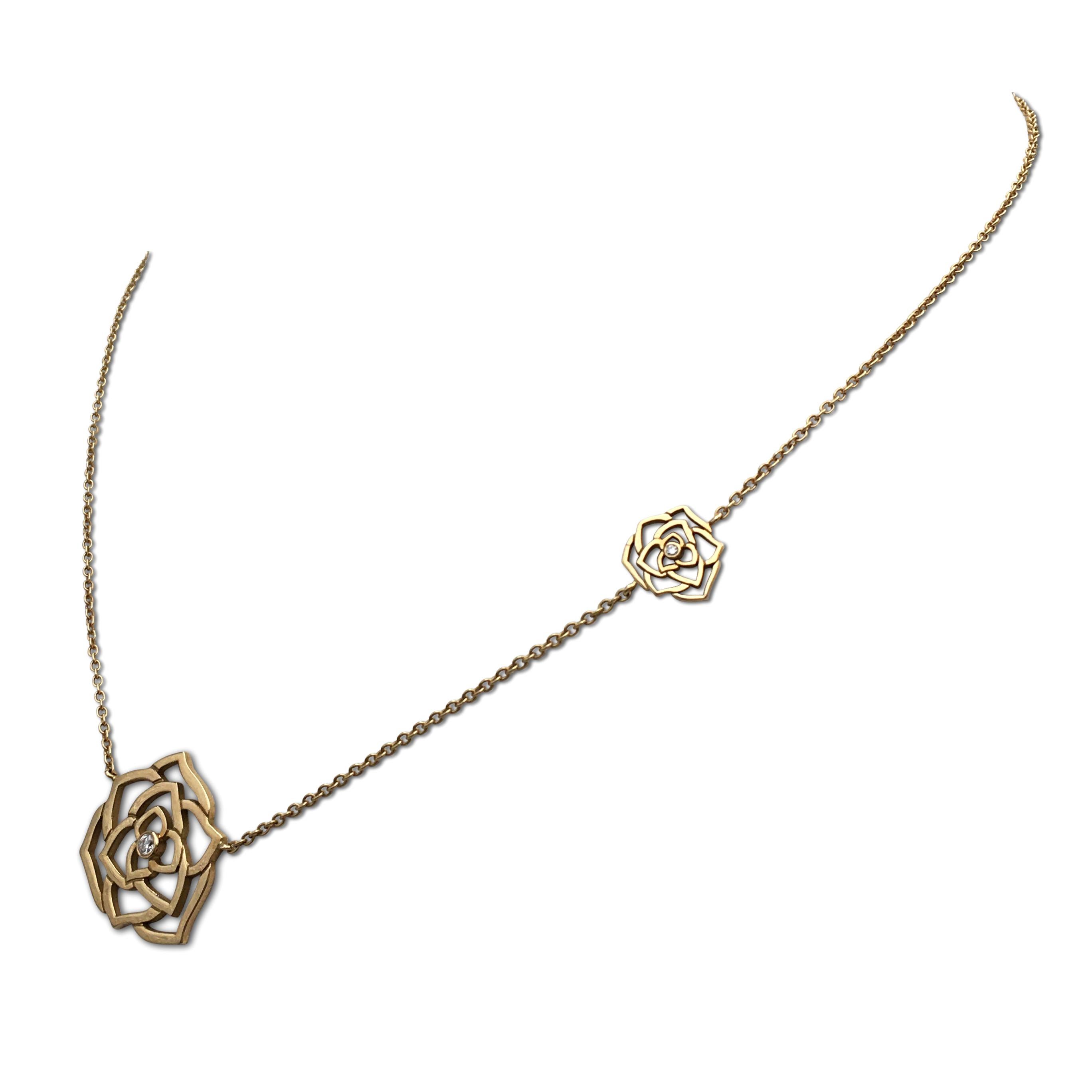 Authentic Piaget necklace from the Rose Collection. Crafted in 18 karat rose gold, the rose pendant features intricate petals and one round brilliant cut diamond weighing an estimated 0.02 carats. The pendant is suspended from a delicate rose gold