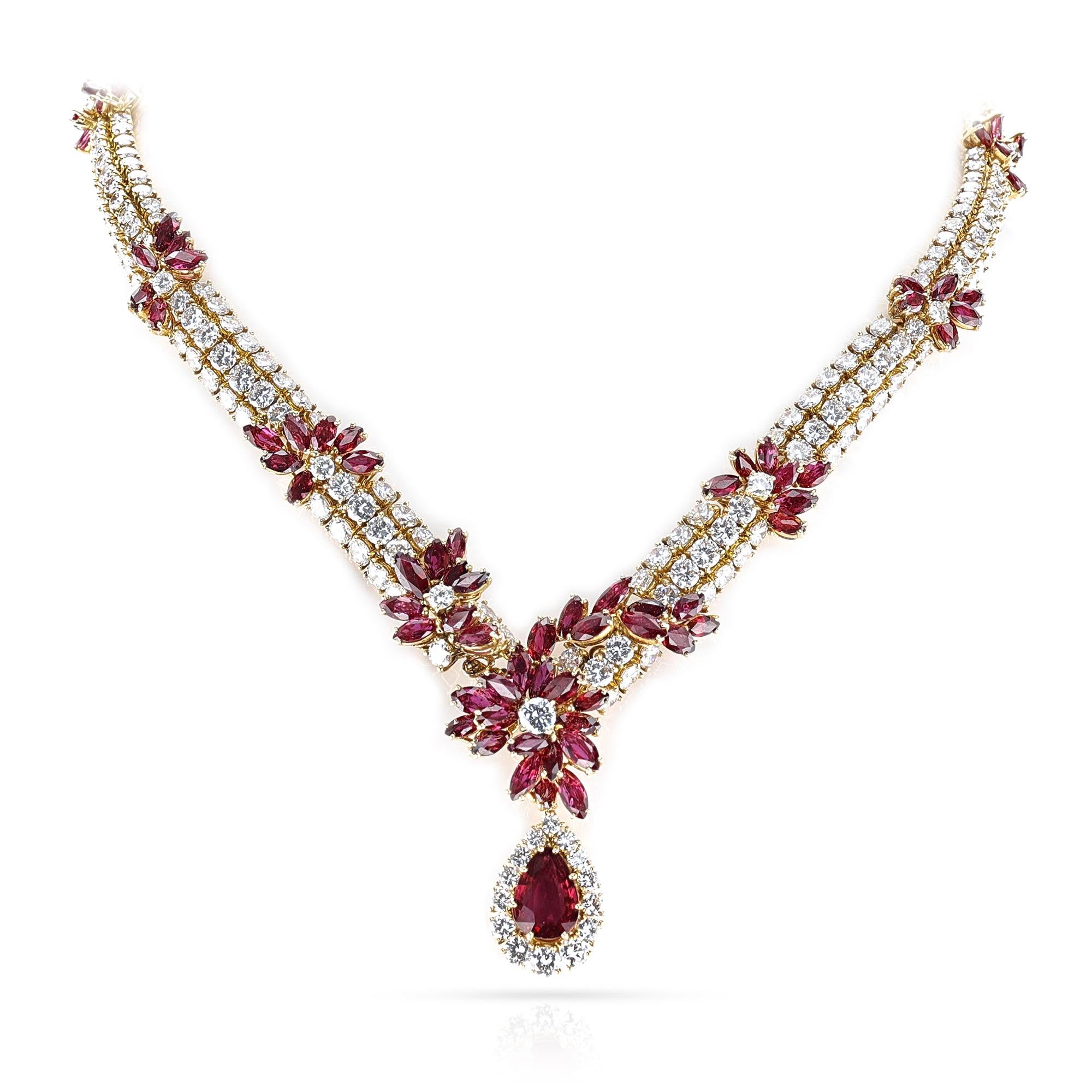 A gorgeous Piaget Ruby and Diamond Necklace and Earring set. The necklace has 405 diamonds for a total of appx. 52 carats and smaller rubies for appx. 23 carats. The large pear ruby in the center weighs approx. 3 carats. The total weight of the