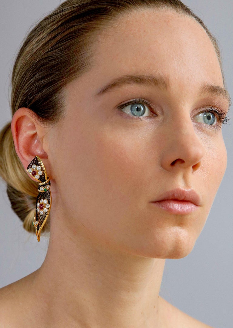 Sophisticated and youthful highly unusual ear clips made in Limited Edition by the renowned Piaget Watch Company featuring a blackened 18K gold net with a rounded polished gold edging designed as tied ribbon bows with applied sparkling diamond