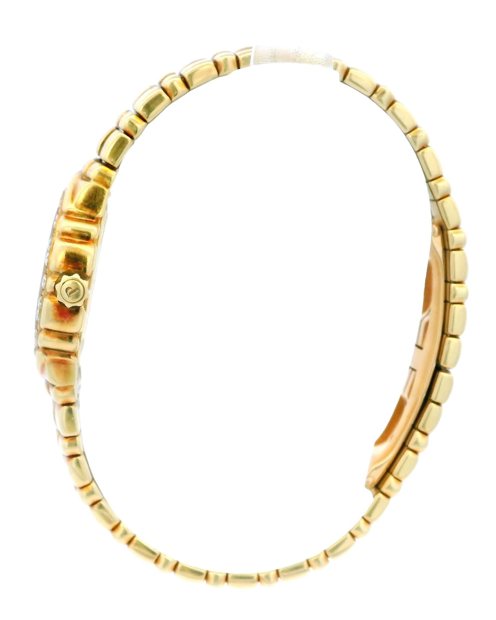 Piaget Tanagra 16033M401D Ladies Watch. This elegant timepiece features a 25mm case made of 18k yellow gold. It includes a stationary yellow gold bezel with factory-set diamonds. The watch has a white dial adorned with gold hands and Roman numeral