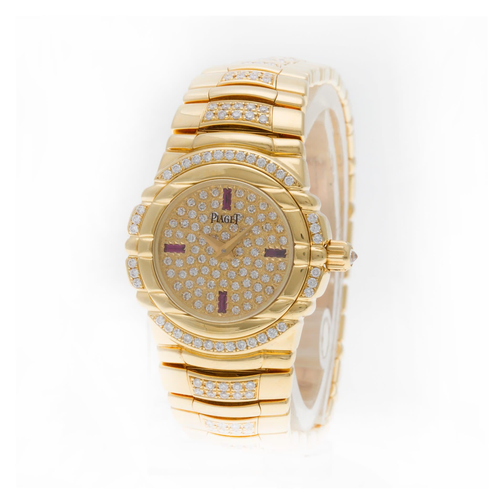 Piaget Tanagra in 18k yellow gold with factory original diamond bezel, pave diamond and ruby dial, and diamond bracelet. Quartz. Ref 16035 M 404 D. 25mm case size. Circa 1990s. Fits 6.25 inches wrist. Fine Pre-owned Piaget Watch.  Certified preowned