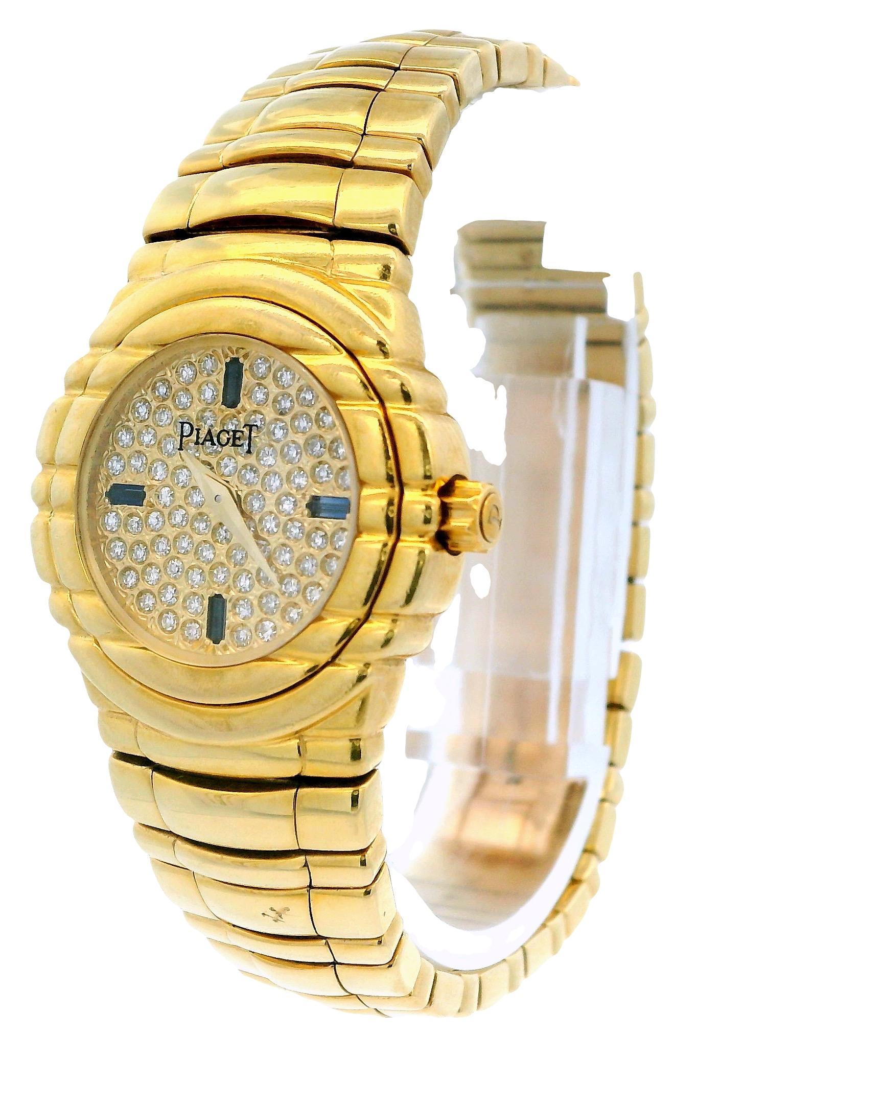 Piaget Tanagra Ladies Watch GOA15262. This exquisite timepiece features a 25mm 18k yellow gold case with a stationary 18k yellow gold bezel. The pave dial is adorned with gold hands and factory-set sapphire hour markers positioned at 3, 6, 9, and 12
