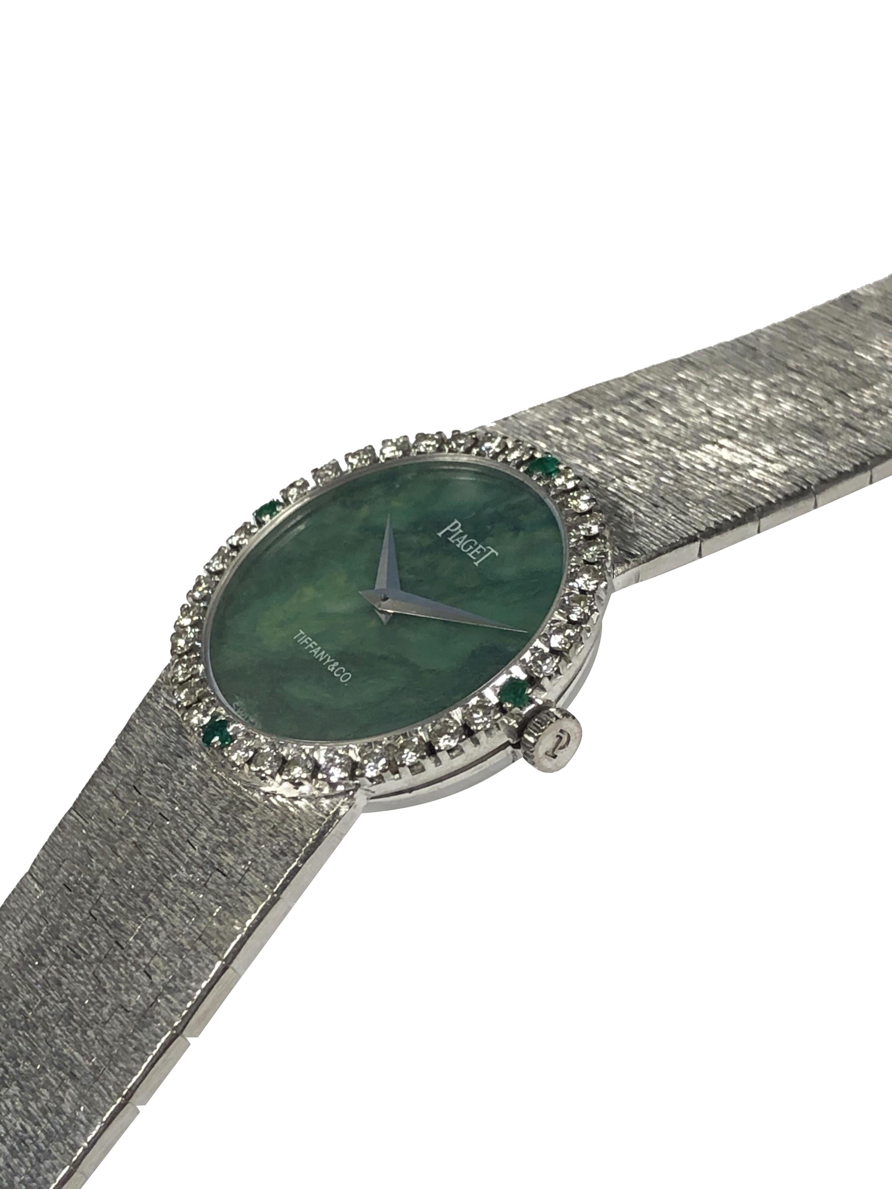 Circa 1970s Piaget For Tiffany & Company Ladies Bracelet Watch, 24 M.M. 2 Piece 18k White Gold case with Round Brilliant cut Diamonds and Emeralds Bezel, Jadite Jade Dial. 17 Jewel Mechanical, Manual wind movement. 5/8 inch wide White Gold textured