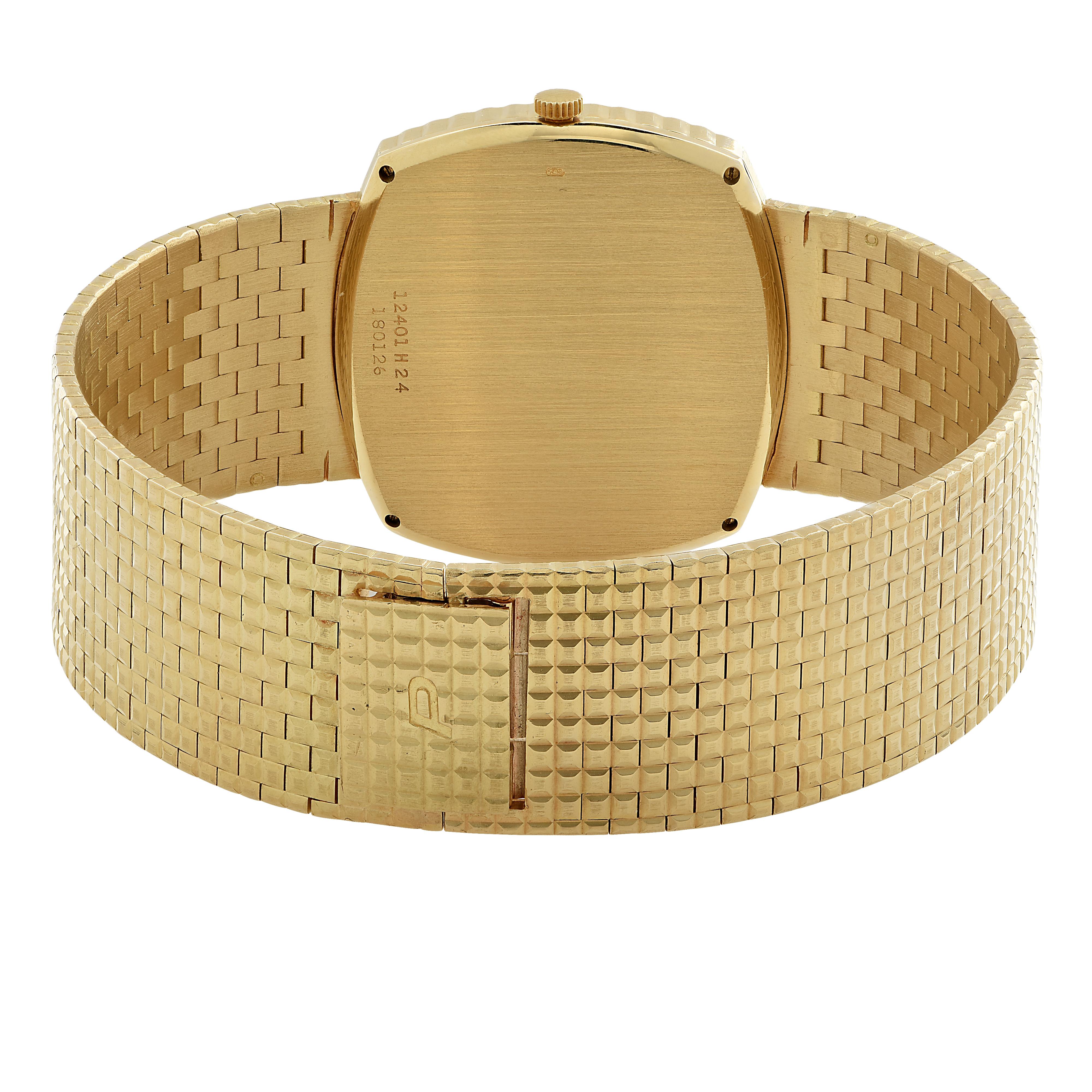 Piaget men’s wrist watch, circa 1980s, crafted in 18 karat yellow gold with a Tiger’s Eye dial measuring 33 mm in diameter. This watch has a manual wind movement, case no. 12401 H 24, Serial no. 180126. The strap measures 7.5 inches in length and .8