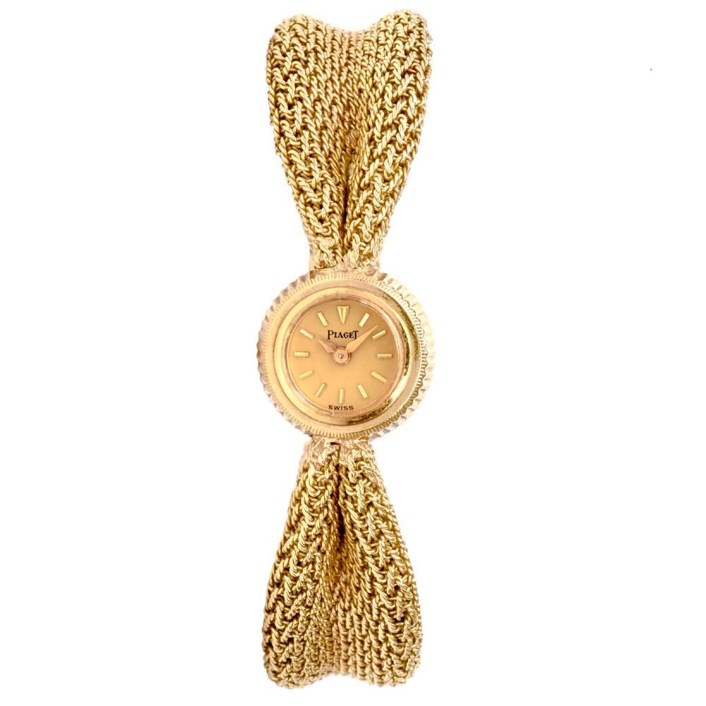 This graceful and feminine Piaget watch is crafted in 18K mesh yellow gold and weighs 38.5 grams. The mesh bracelet is clasped on the edges giving an aesthetically pleasing ribbon-like texture. The sides of the clasp feature fine geometrical