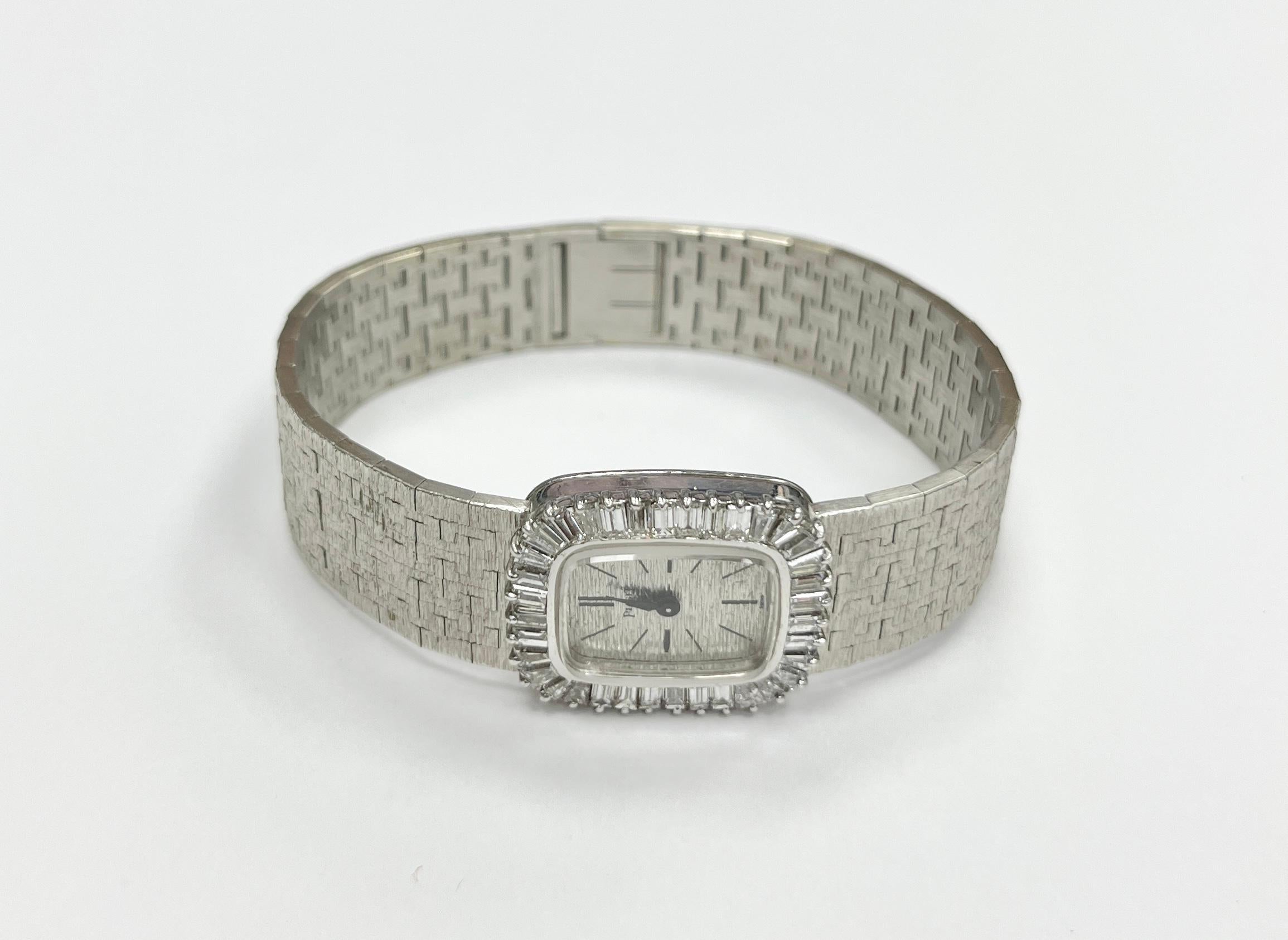 1960' PIAGET 18K white gold diamond bezel ladies watch, containing numerous straight and tapered baquette diamonds, 35 dias approx 1.10 cts, textured silvered dial, manual wind movement, integrated textured mesh link bracelet, fold over clasp
6 1/4