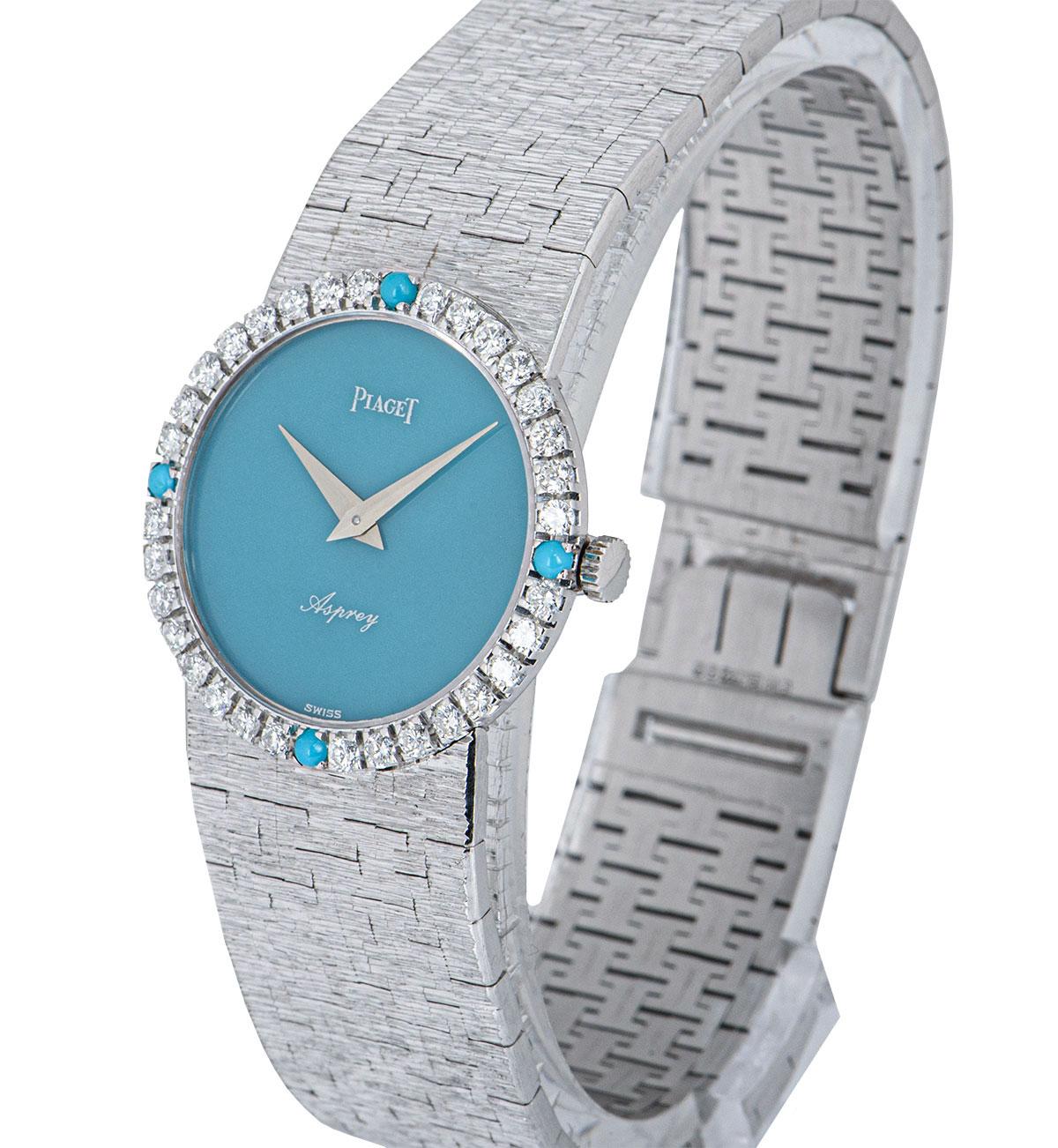 A 24 mm 18k White Gold Vintage Ladies Dress Wristwatch, double name Asprey turquoise stone dial, a fixed 18k white gold bezel set with 32 round brilliant cut diamonds and 4 turquoise stones, an 18k white gold textured integrated bracelet with an 18k