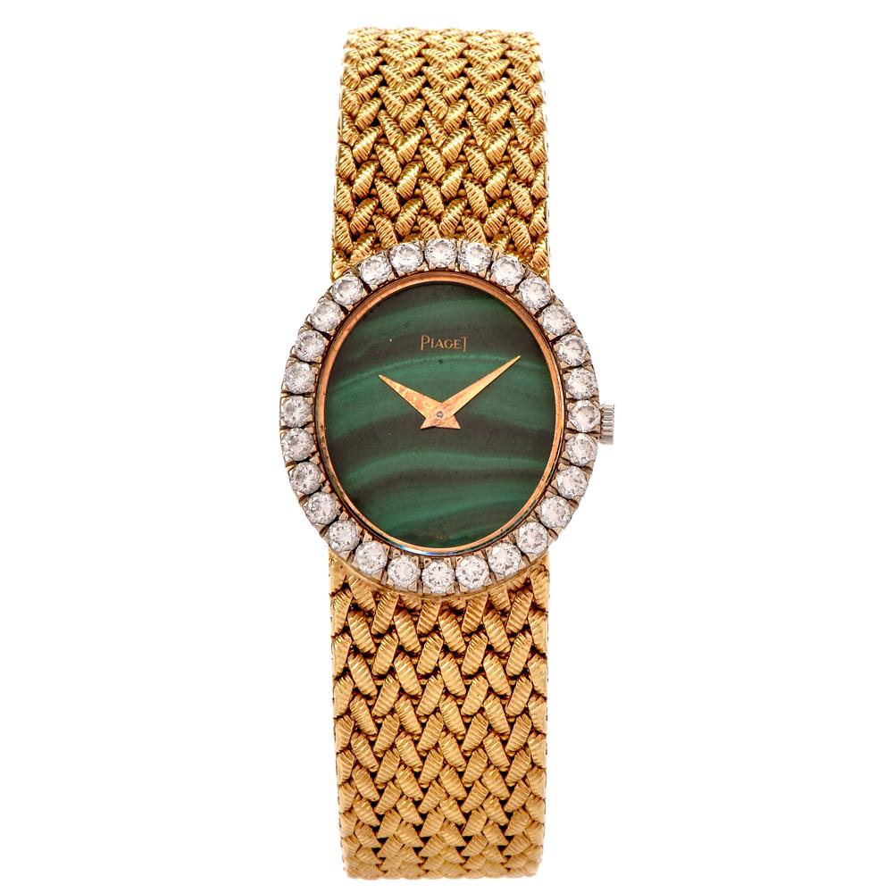 This stunning 18k yellow gold 1960'd vintage Piaget watch is in 18k yellow gold . it features a beautiful Malachite dial with diamond bezel. The bezel is set with 30 factory set round brilliant cut diamonds weighing an estimated 2.10 carats of the