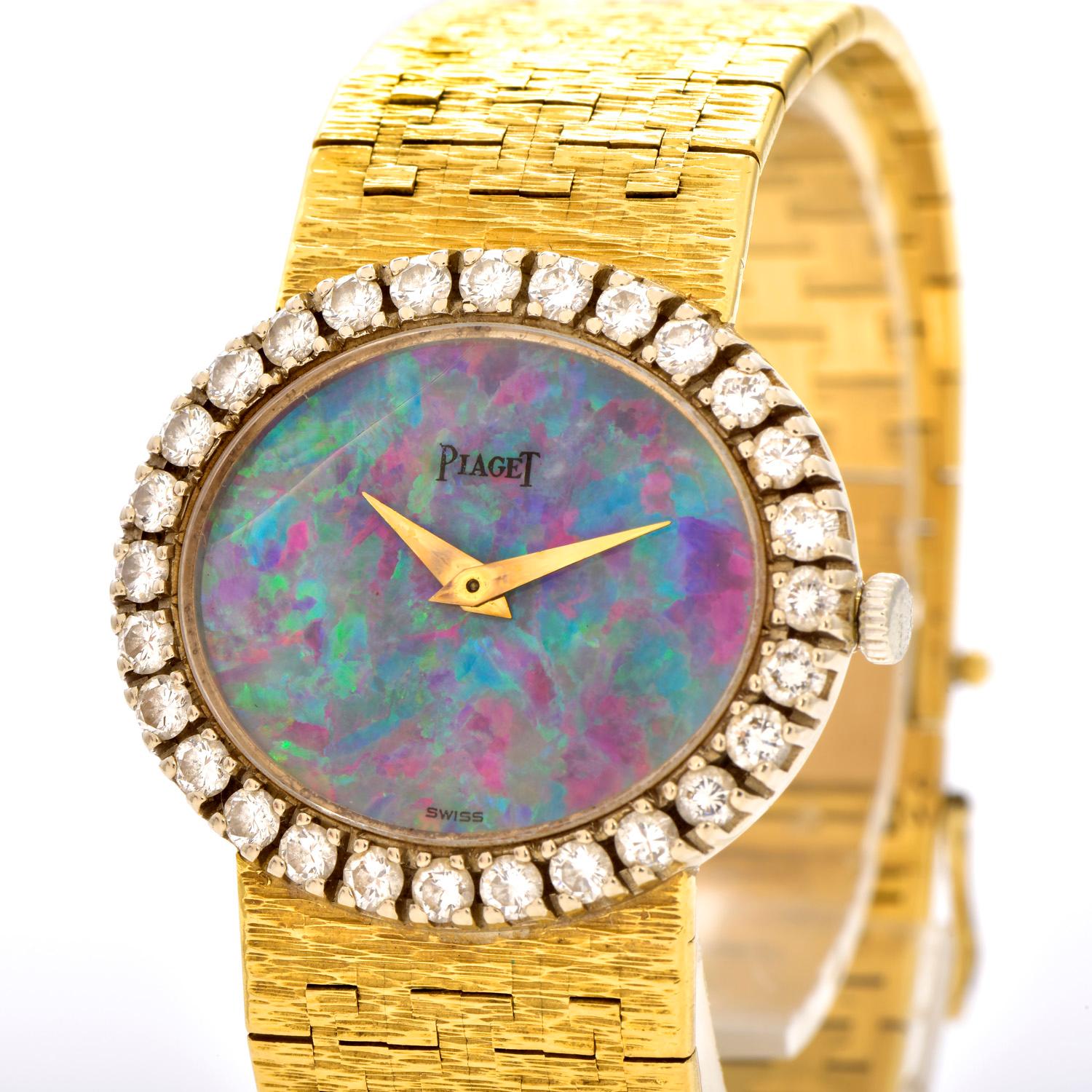 This Piaget Opal and Diamond 18K Gold Designer Wrist Watch.

This is a rare variation of the PIAGET depose collection presenting an Opal dial.

Expertly crafted in solid heavy 18K yellow and white gold,  the bezel is composed of  (28) Genuine