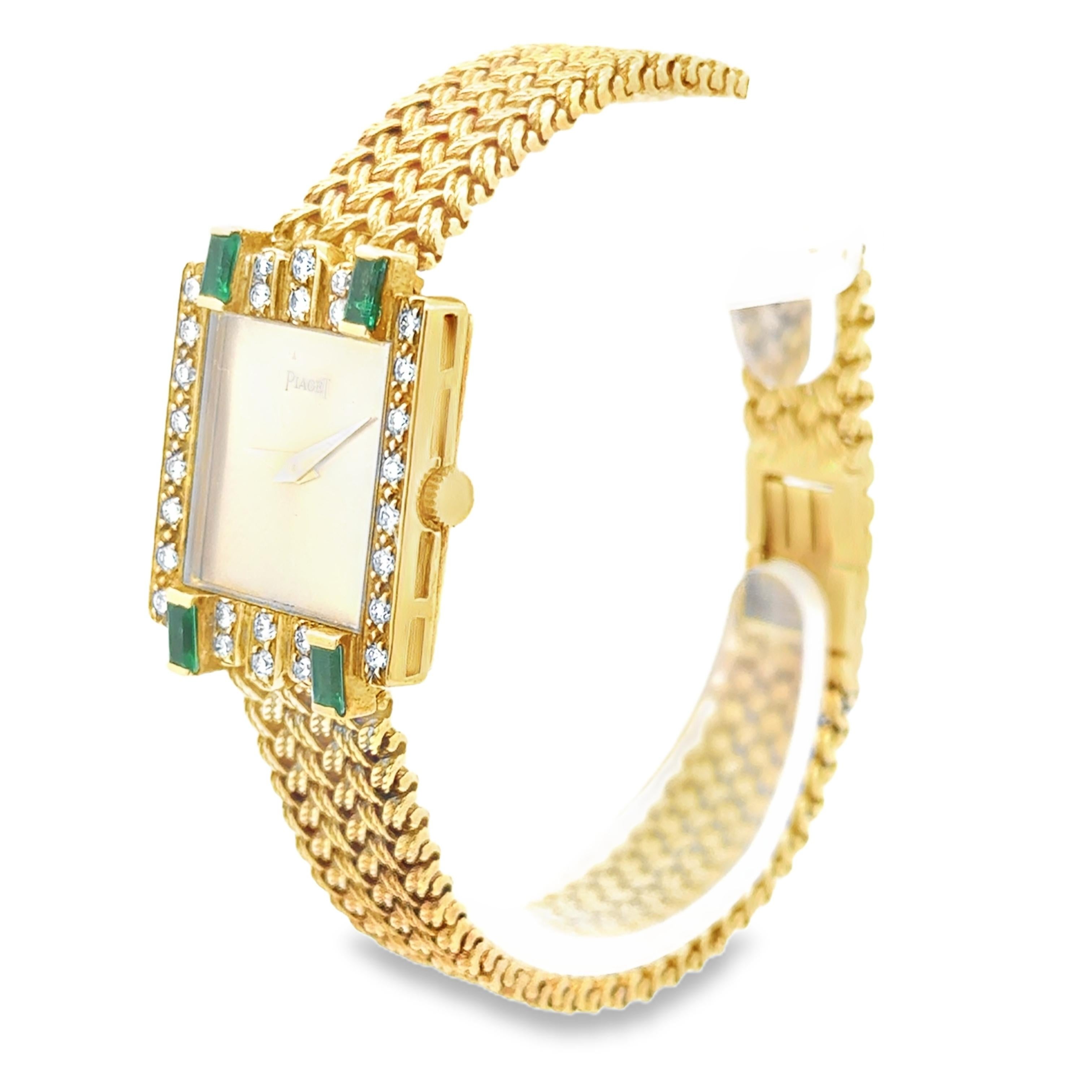 A vintage ladies' watch created by Piaget, featuring a bezel adorned with 28 round brilliant cut diamonds and 4 baguette cut emeralds. Accented by an 18K yellow gold bracelet with a classic woven design. 