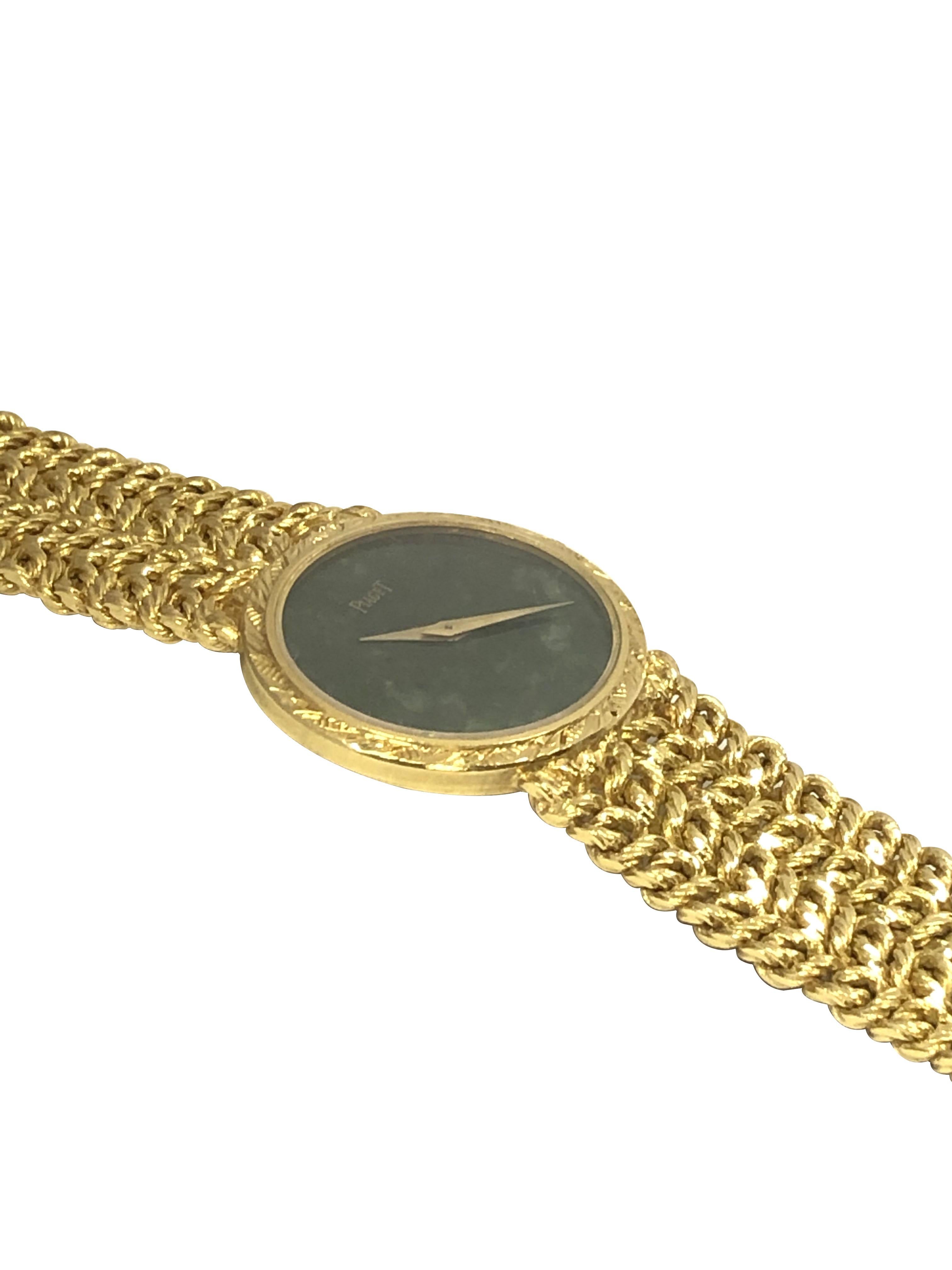 Circa 1970s Piaget ladies Wrist Watch, 27 X 24 M.M. 18k Yellow Gold 2 piece case, Mechanical, Manual wind 17 Jewel Movement, Nephrite Dial with Gold Hands. 5/8 inch wide soft link bracelet with Piaget Logo clasp. watch length 7 1/2 inches. Comes in